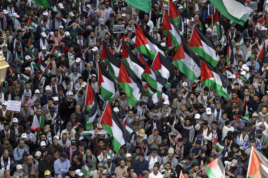 People lift flags of Palestine during a national march in support of Palestinians and against Morocco's normalisation of ties with Israel, in the capital Rabat on April 6, 2025. (Photo by Abdel Majid BZIOUAT / AFP)