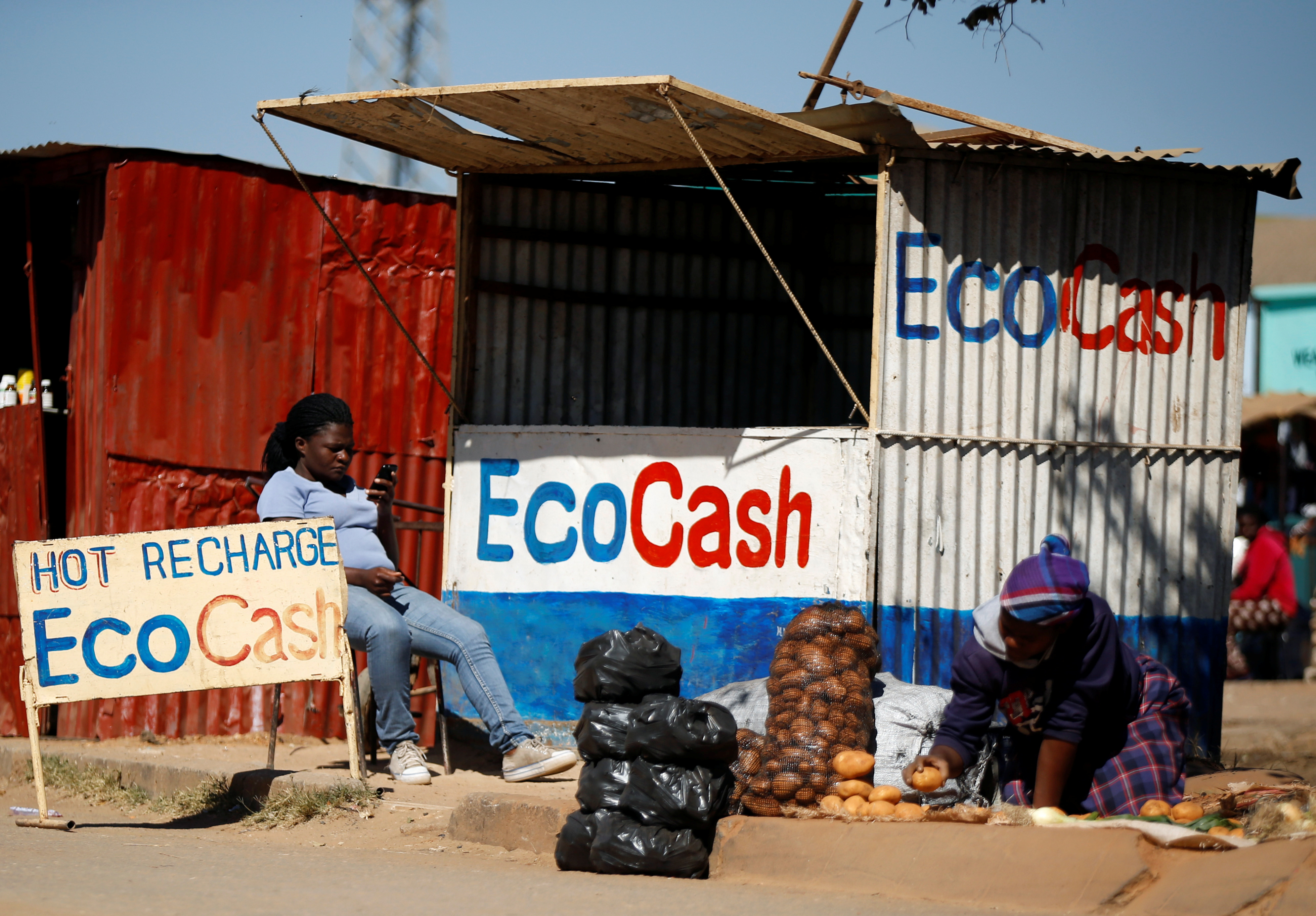 A street vendor awaits customers outside a stall at a marketplace in Chitungwiza, Zimbabwe, July 16, 2019. Picture taken July 16, 2019. REUTERS/Philimon Bulawayo