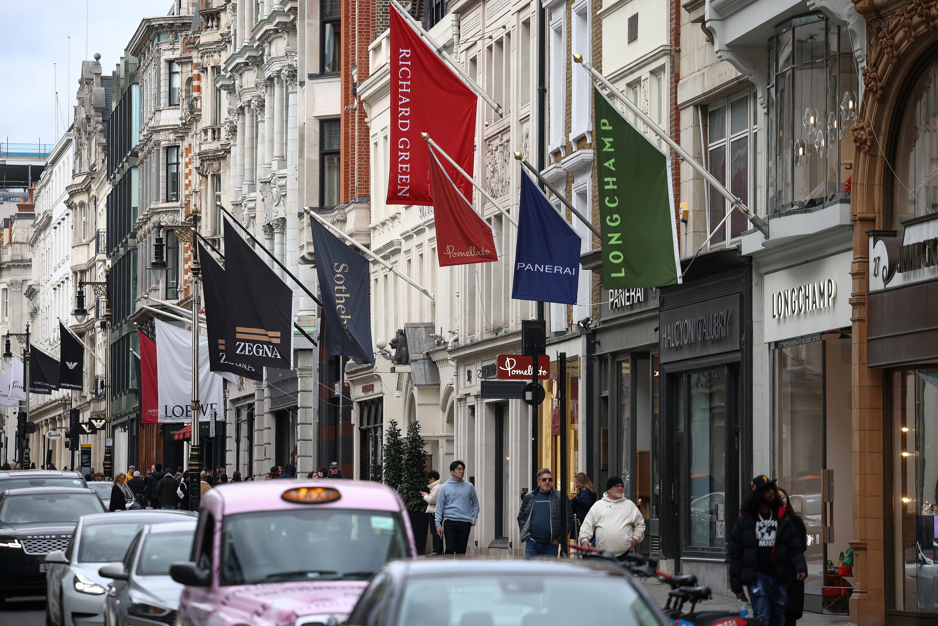 People walk past luxury shops on New Bond Street in London, Britain, March 11, 2023. REUTERS/Henry Nicholls