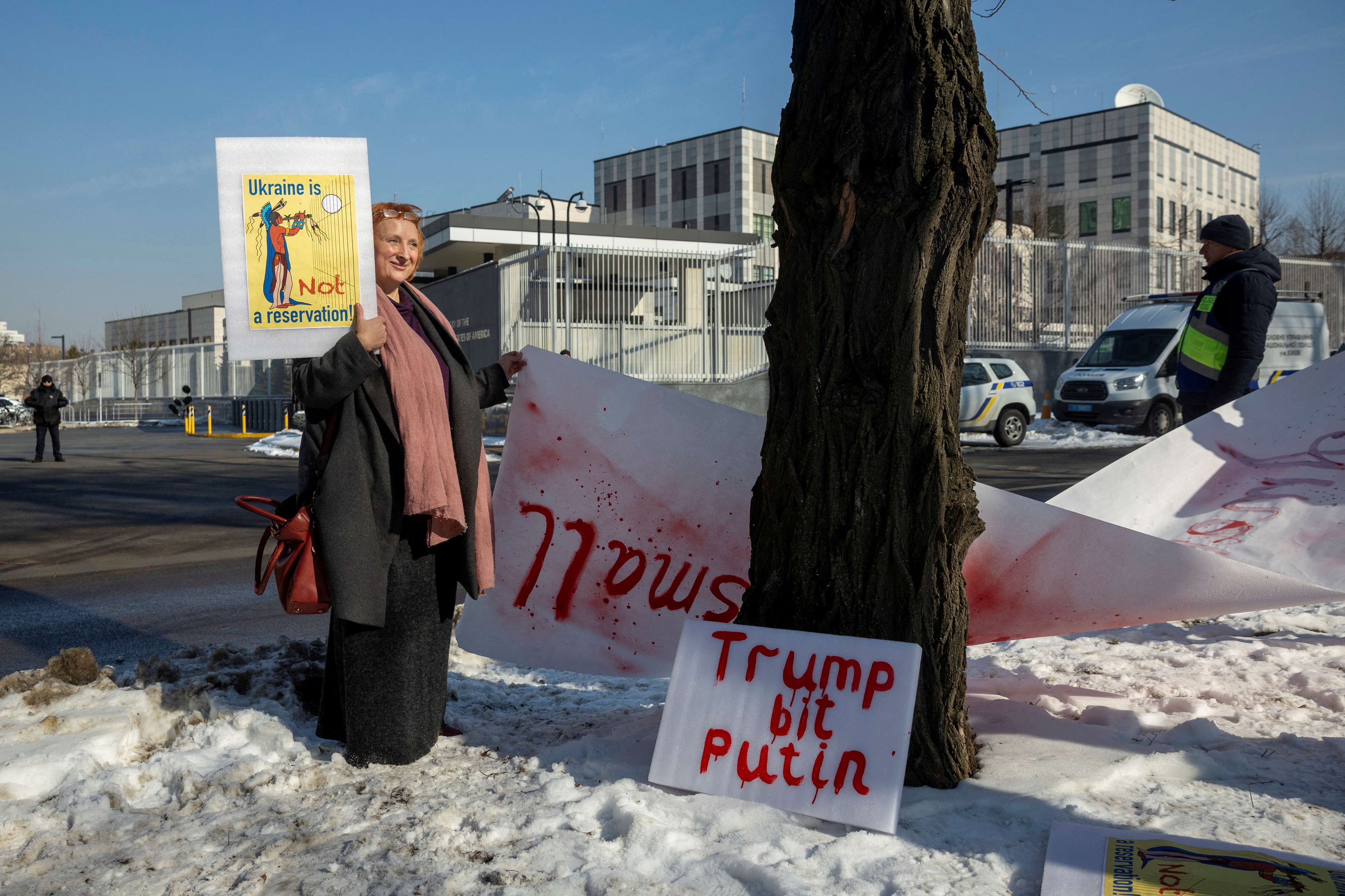 Woman holds a placard during a protest against a potential critical minerals deal between the U.S. and Ukraine
