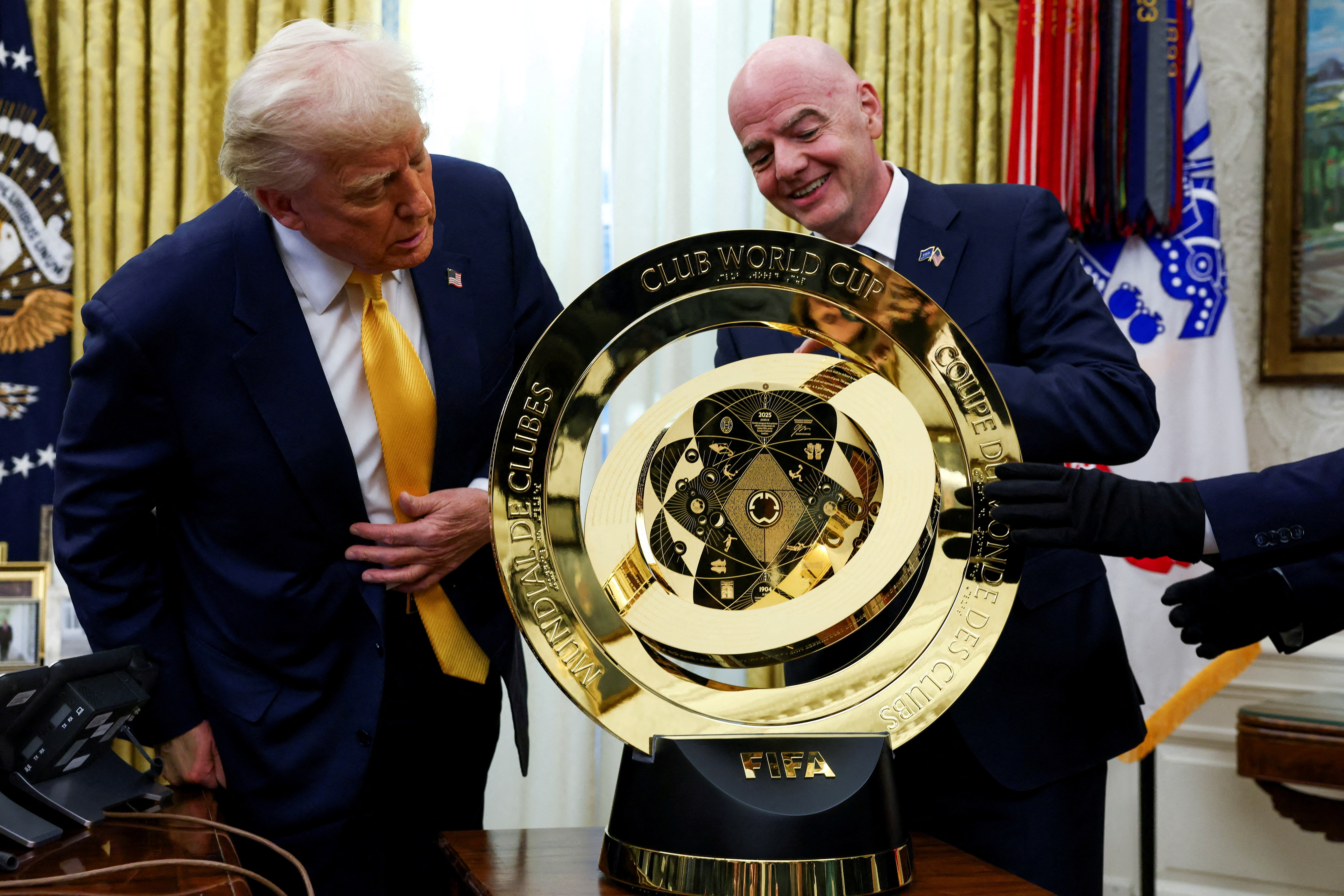 U.S. President Donald Trump and FIFA President Gianni Infantino stand next to the FIFA Club World Cup trophy in the Oval Office of the White House in Washington, D.C., U.S., March 7, 2025. REUTERS/Evelyn Hockstein TPX IMAGES OF THE DAY
