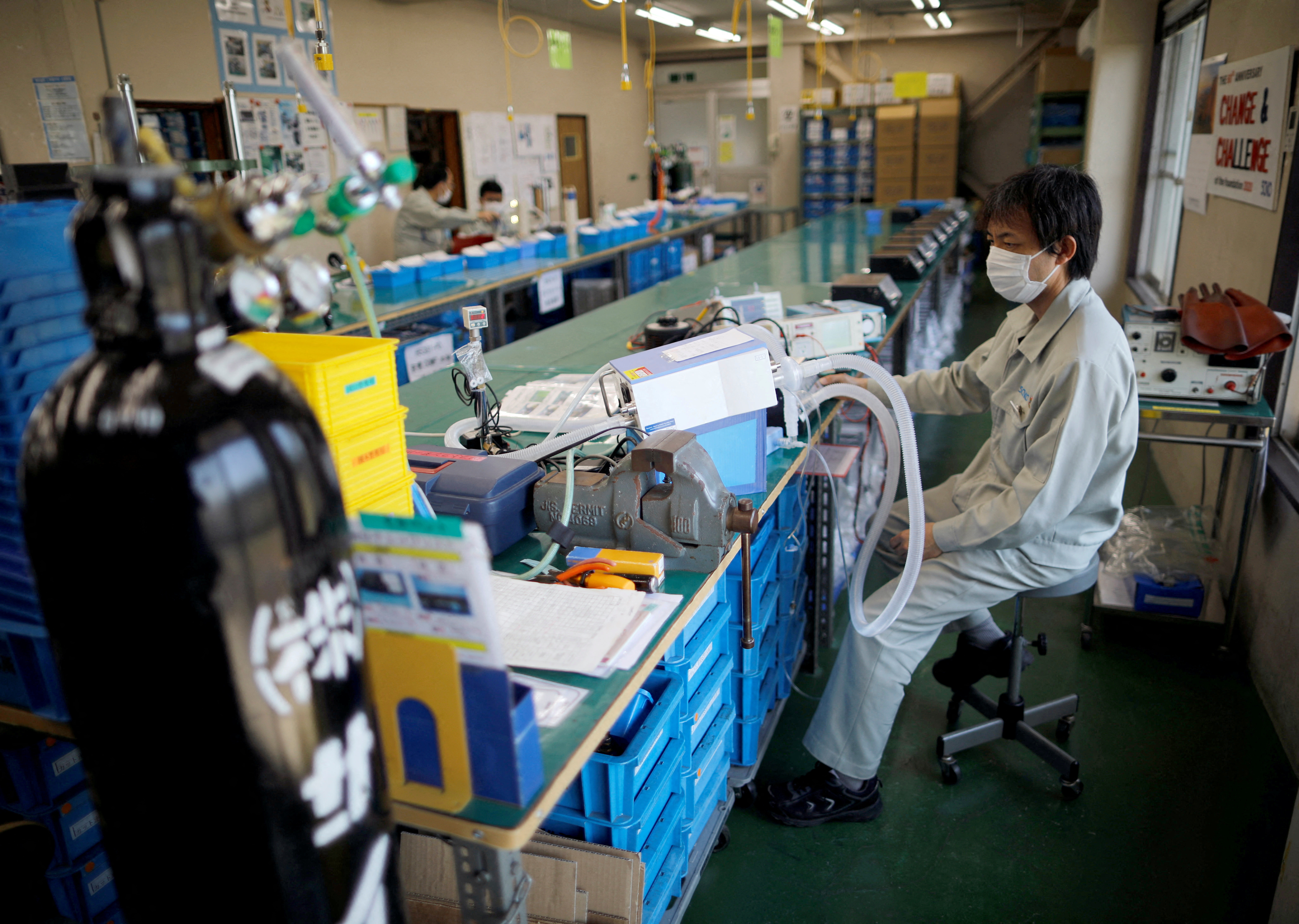 FILE PHOTO: FILE PHOTO: Employees of Sanko Manufacturing Co. are seen at the assembly line of the company's ventilators at a factory in Saitama, north of Tokyo, Japan May 8, 2020. Picture taken May 8, 2020. REUTERS/Issei Kato/File Photo/File Photo