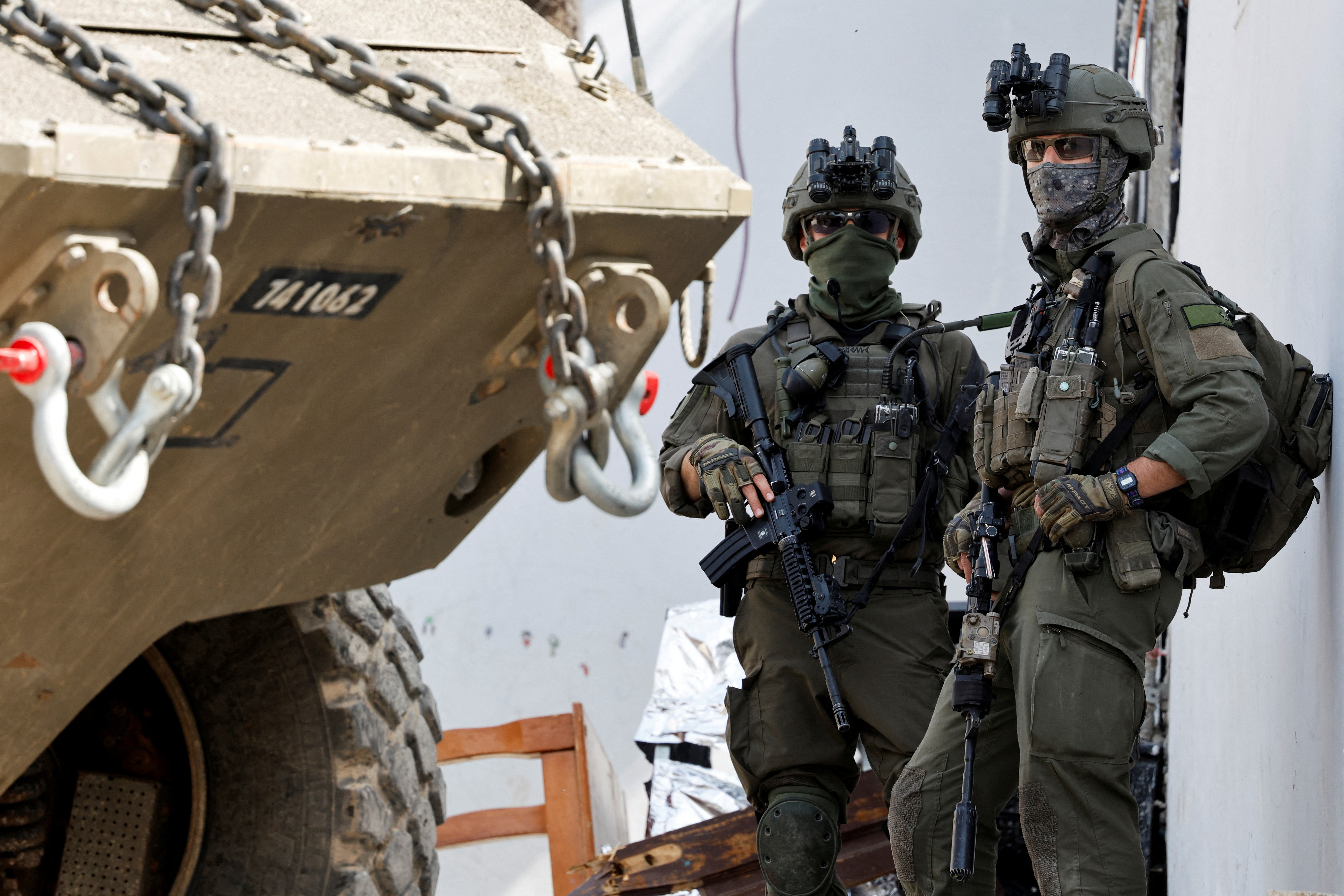 FILE PHOTO: Israeli soldiers stand next to a military vehicle during an Israeli raid in Jenin, in the Israeli-occupied West Bank, March 4, 2025. REUTERS/Raneen Sawafta/File Photo