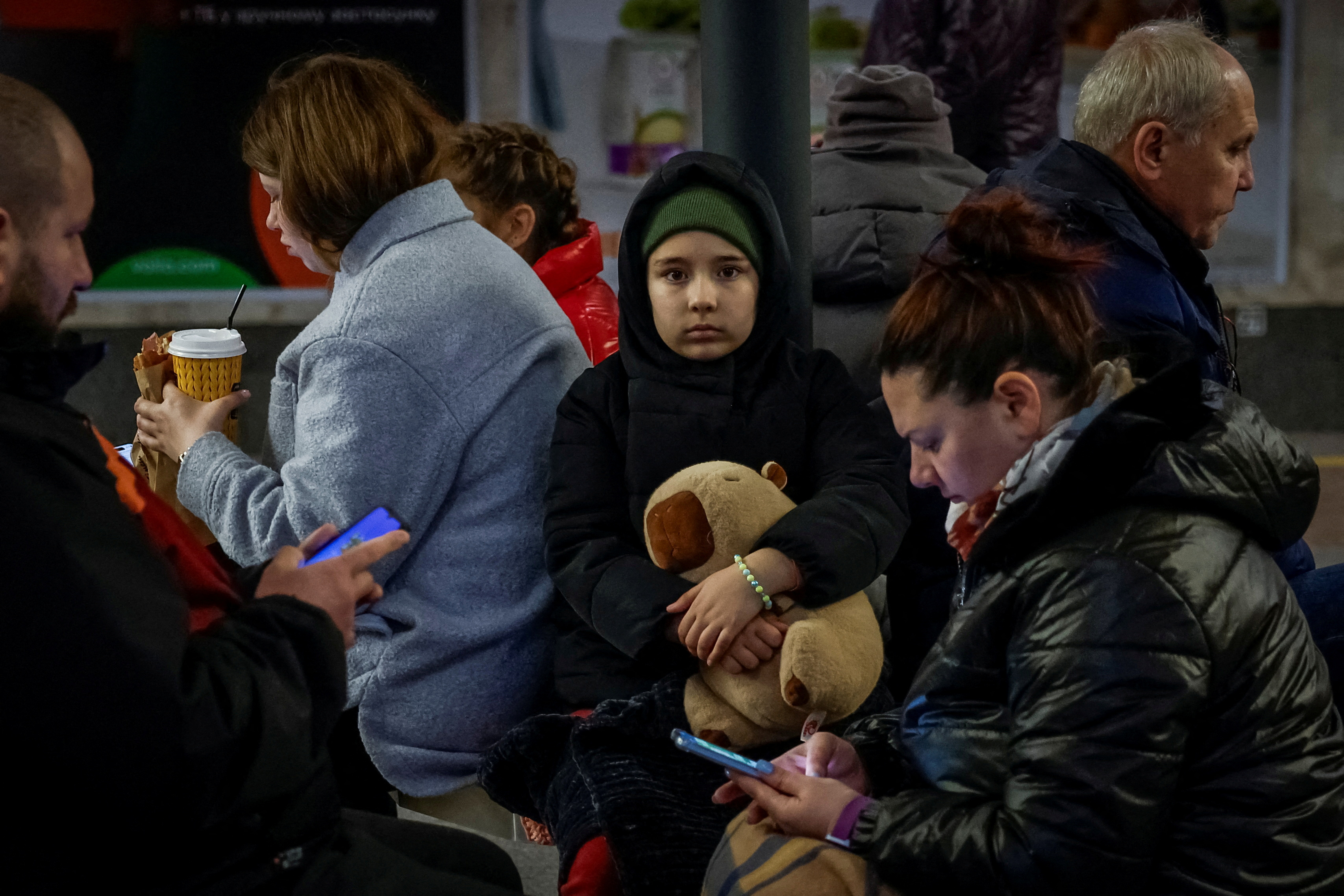 A child holds a toy while taking shelter with parents inside a metro station during a Russian military strike, amid Russia's attack on Ukraine, in Kyiv, Ukraine April 6, 2025. REUTERS/Alina Smutko TPX IMAGES OF THE DAY