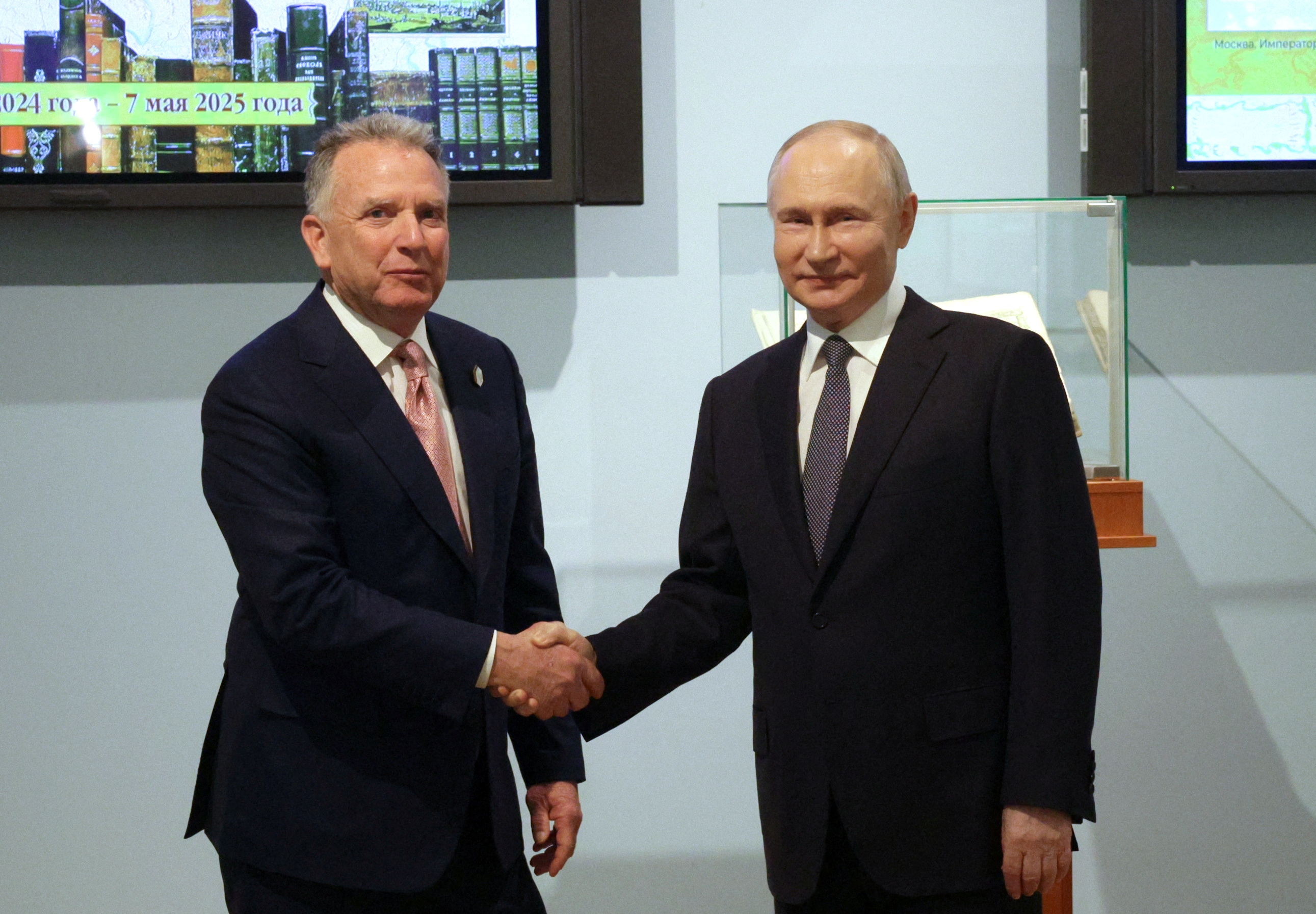 Witkoff and Putin shake hands.