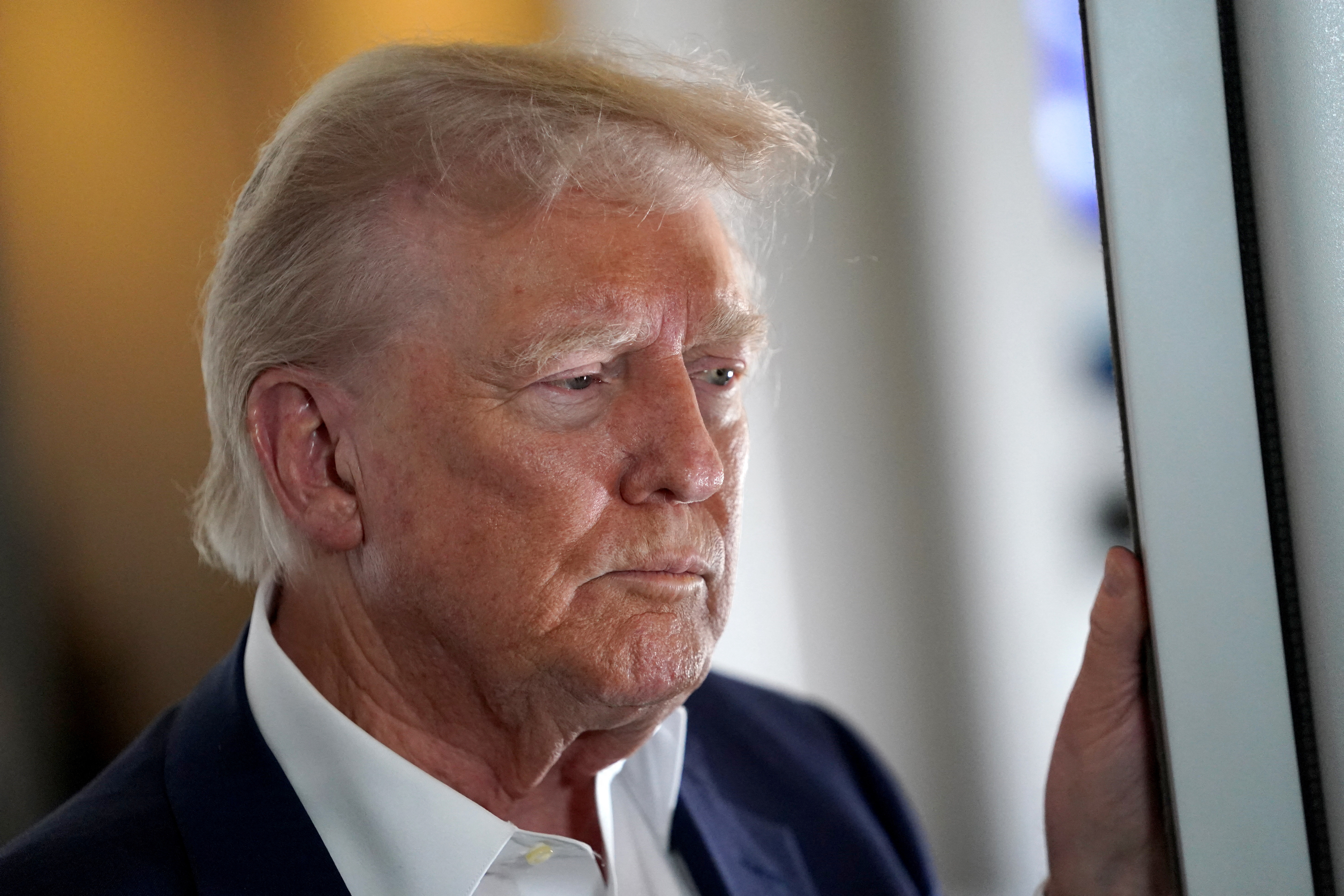 U.S President Donald Trump speaks to members of press onboard Air Force One on a flight to Fiumicino Airport near Rome to attend the funeral of Pope Francis, April 25, 2025. REUTERS/Nathan Howard