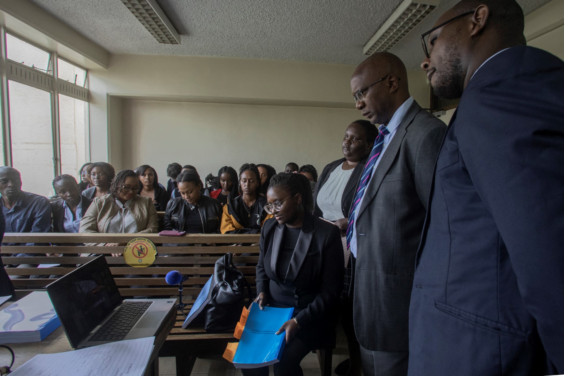 Kenyan lawyer, Mercy Mutemi (seated 4th R) along with fellow counsel follow proceedings during a court session.