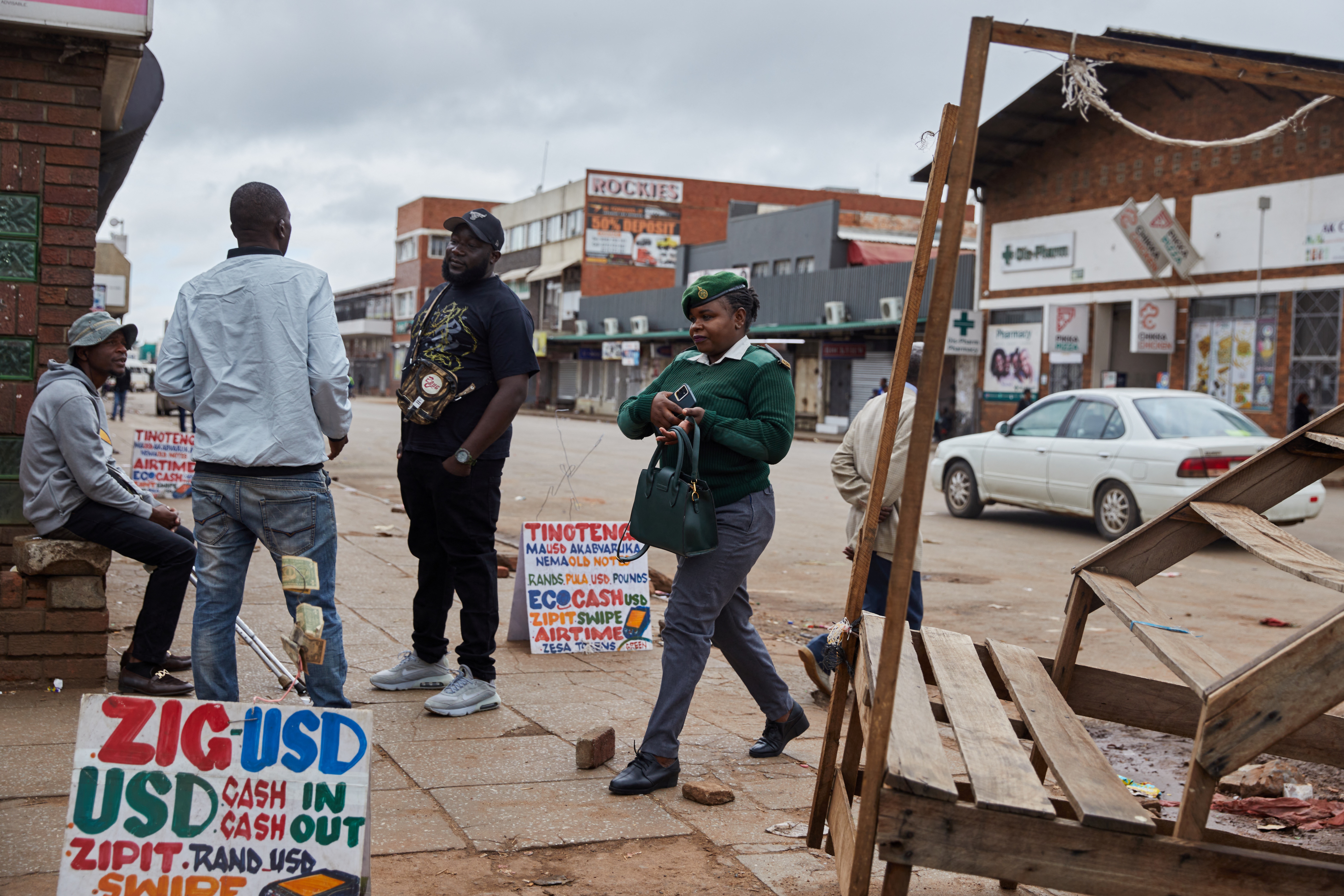 A prisons officer walks past empty protest area in Harare