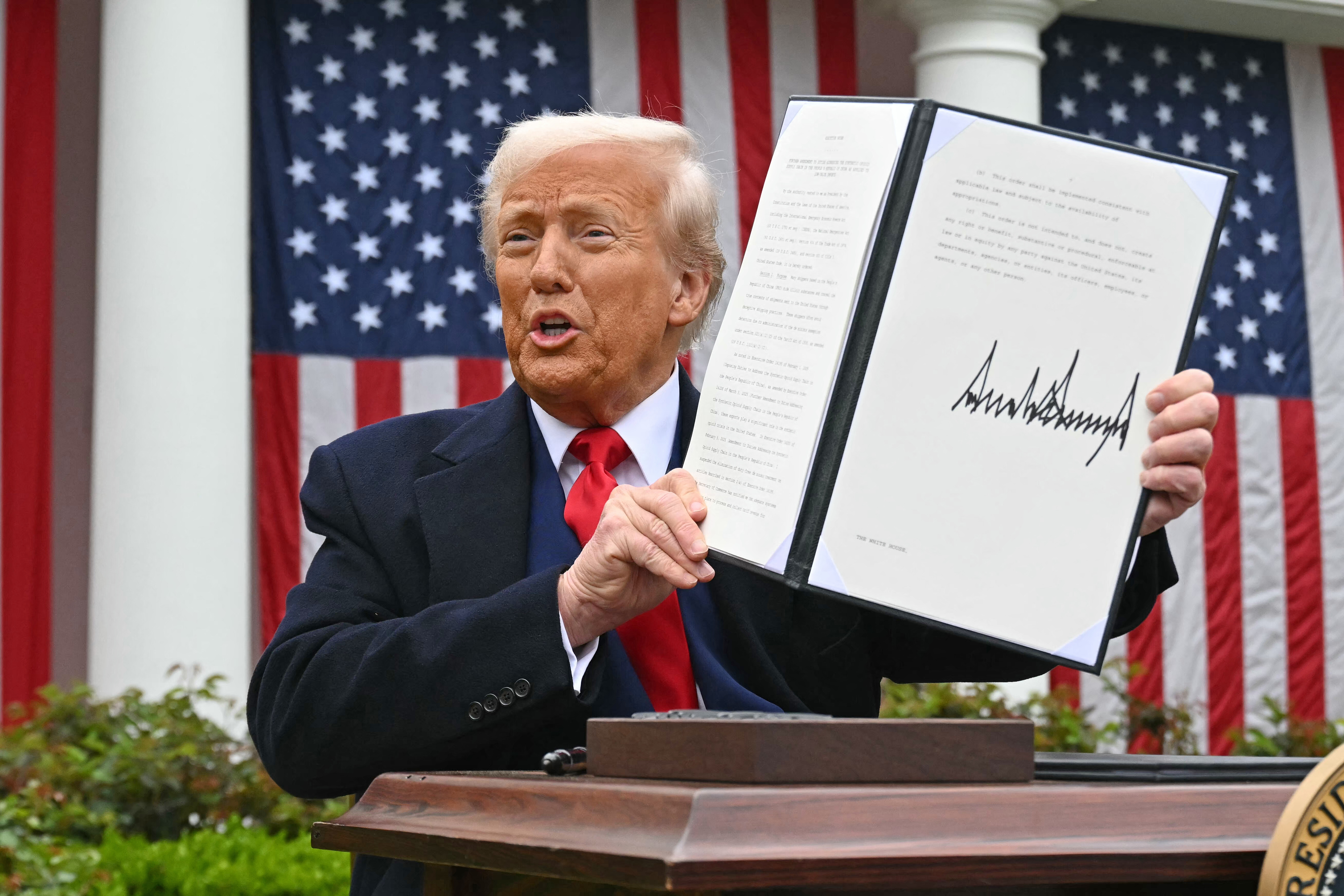 US President Donald Trump holds a signed executive order after delivering remarks on reciprocal tariffs during an event in the Rose Garden entitled "Make America Wealthy Again" at the White House in Washington, DC, [File: Saul Loeb/AFP]