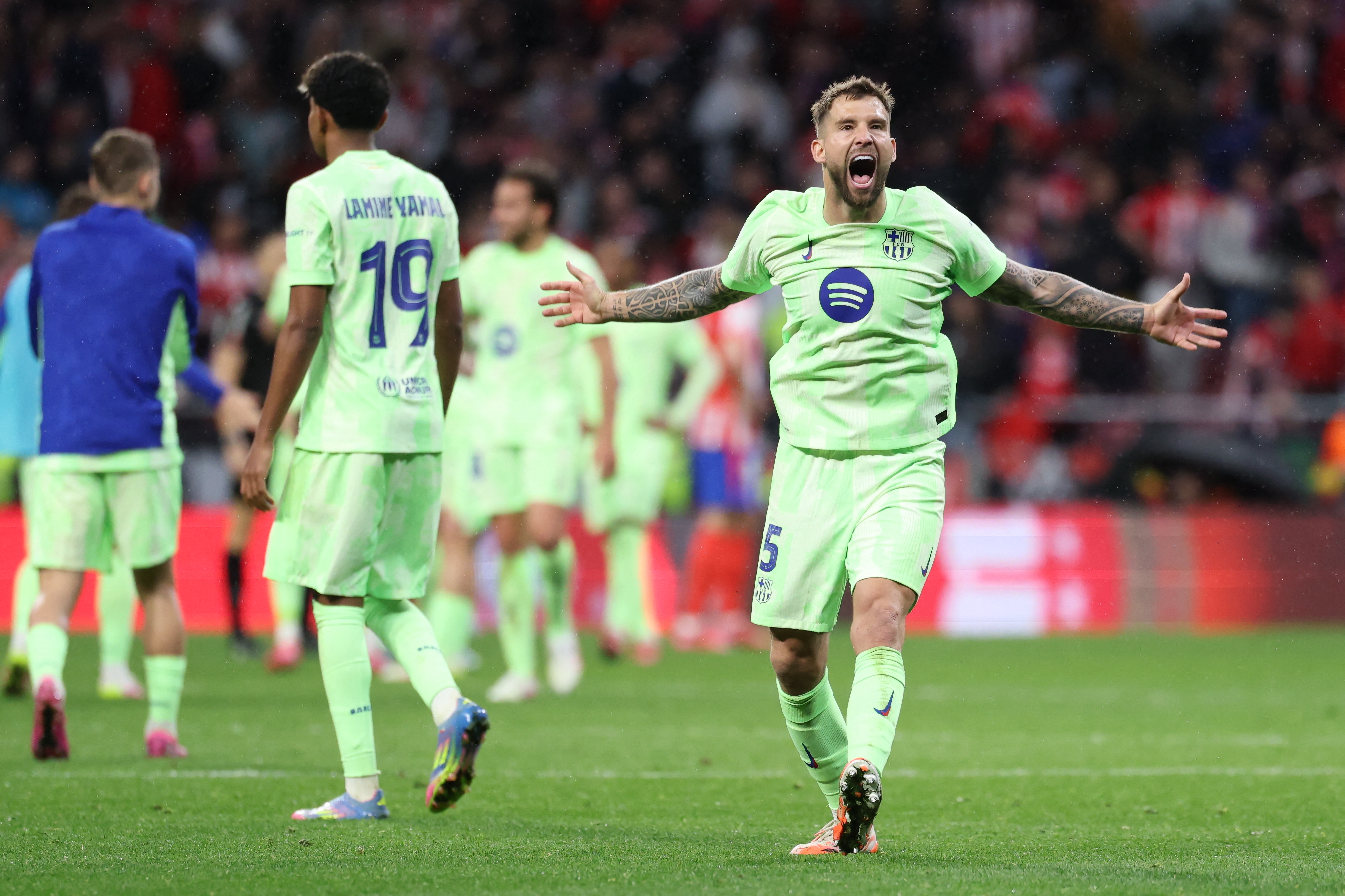 Barcelona's Spanish defender #05 Inigo Martinez Berridi and teammates celebrate at the end of the Spanish Copa del Rey (King's Cup) semi-final second leg football match between Club Atletico de Madrid and FC Barcelona at Metropolitano Stadium in Madrid on April 2, 2025. (Photo by Thomas COEX / AFP)