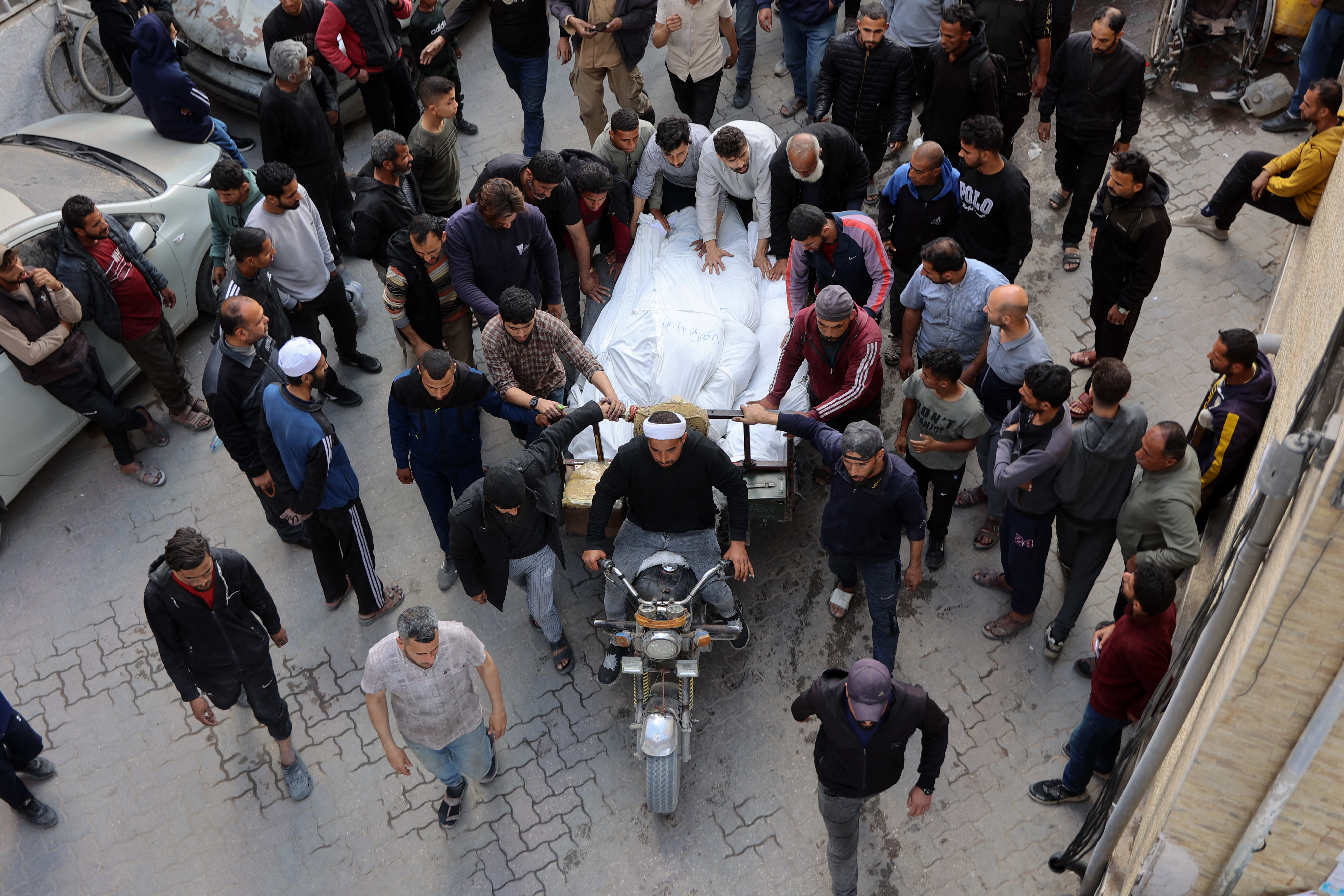 Palestinians transport the bodies of people killed in an Israeli raid.