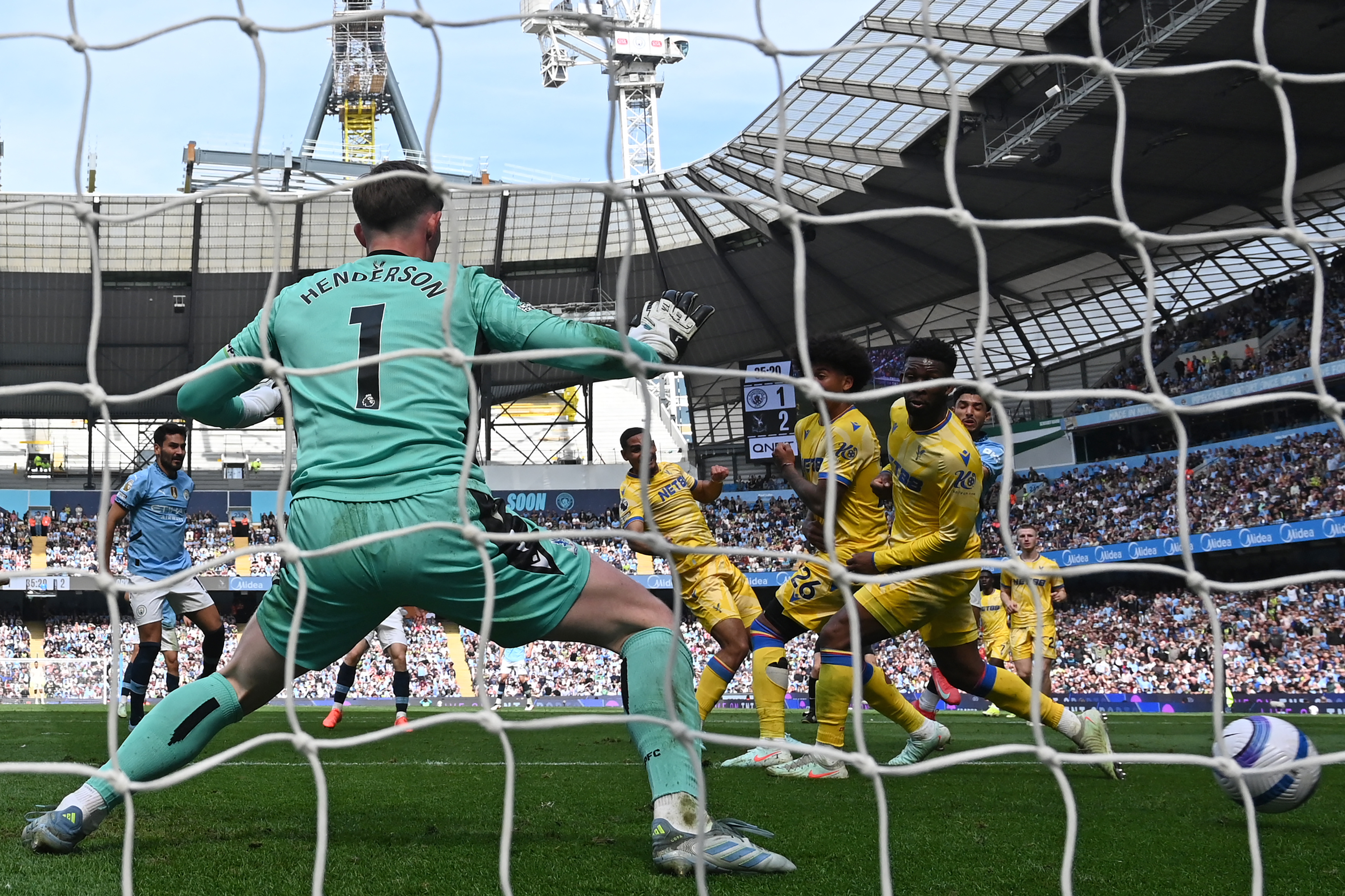 Manchester City's Egyptian striker #07 Omar Marmoush (R) scores their second goal past Crystal Palace's English goalkeeper #01 Dean Henderson (L) during the English Premier League football match between Manchester City and Crystal Palace at the Etihad Stadium in Manchester, north west England, on April 12, 2025. (Photo by Paul ELLIS / AFP) / RESTRICTED TO EDITORIAL USE. NO USE WITH UNAUTHORIZED AUDIO, VIDEO, DATA, FIXTURE LISTS, CLUB/LEAGUE LOGOS OR 'LIVE' SERVICES. ONLINE IN-MATCH USE LIMITED TO 120 IMAGES. AN ADDITIONAL 40 IMAGES MAY BE USED IN EXTRA TIME. NO VIDEO EMULATION. SOCIAL MEDIA IN-MATCH USE LIMITED TO 120 IMAGES. AN ADDITIONAL 40 IMAGES MAY BE USED IN EXTRA TIME. NO USE IN BETTING PUBLICATIONS, GAMES OR SINGLE CLUB/LEAGUE/PLAYER PUBLICATIONS. /