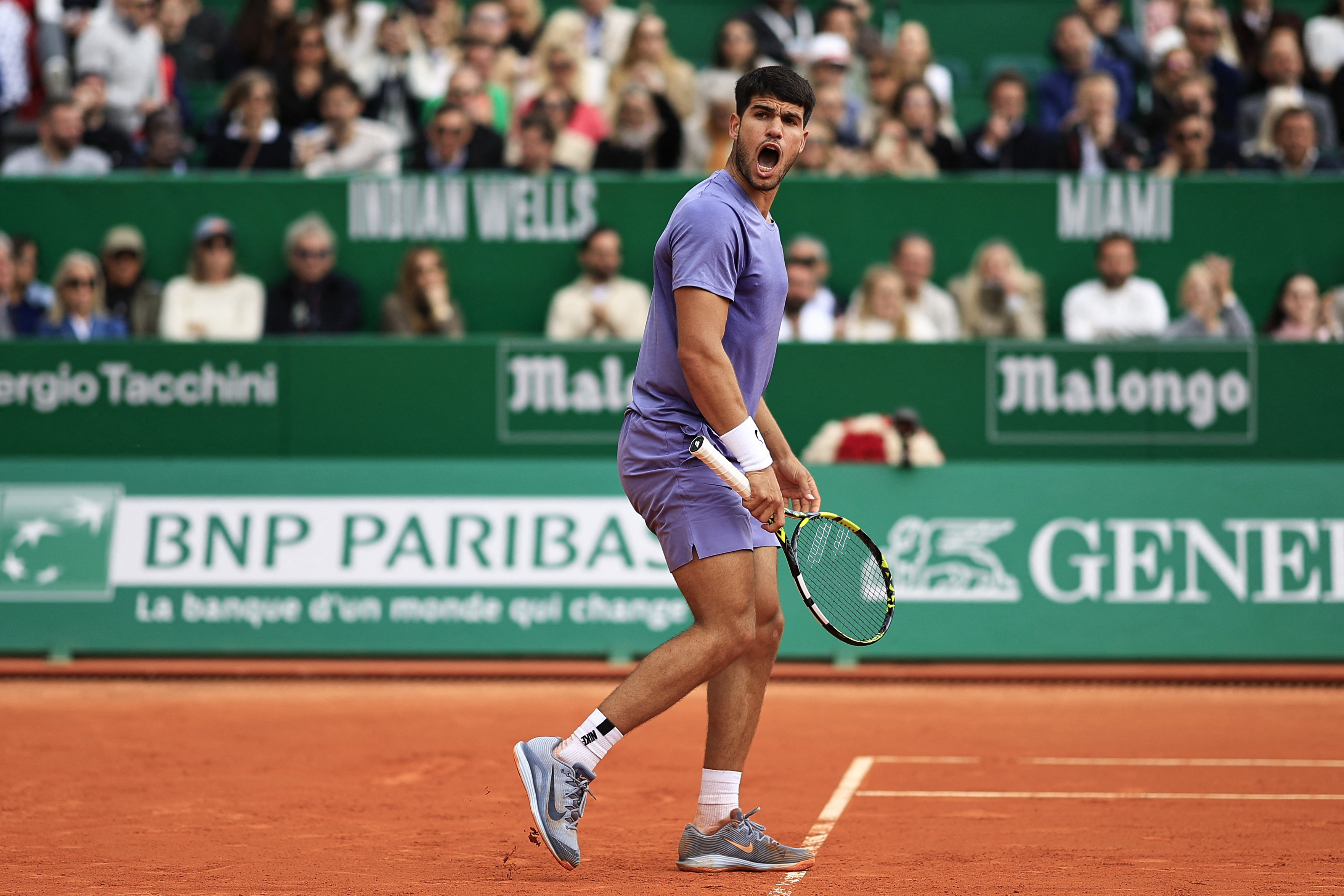 Spain's Carlos Alcaraz reacts after a point as he plays against Italy's Lorenzo Musetti during the Monte Carlo ATP Masters Series Tournament final tennis match at the Monte Carlo Country Club in Roquebrune-Cap-Martin on April 13, 2025. (Photo by Valery HACHE / AFP)