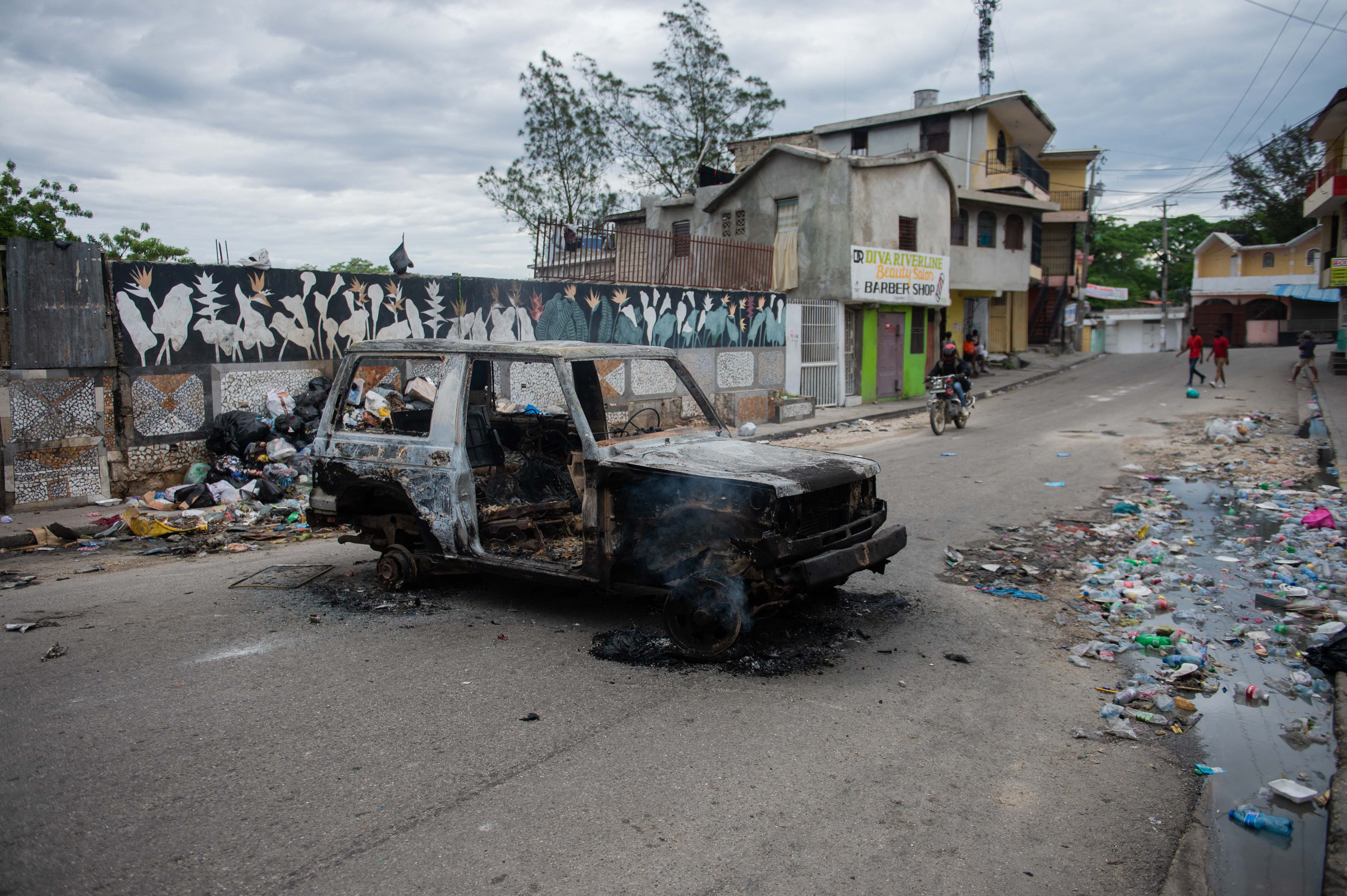 A burnt-out car is seen during a protest against insecurity in Port-au-Prince, Haiti on April 16, 2025.
