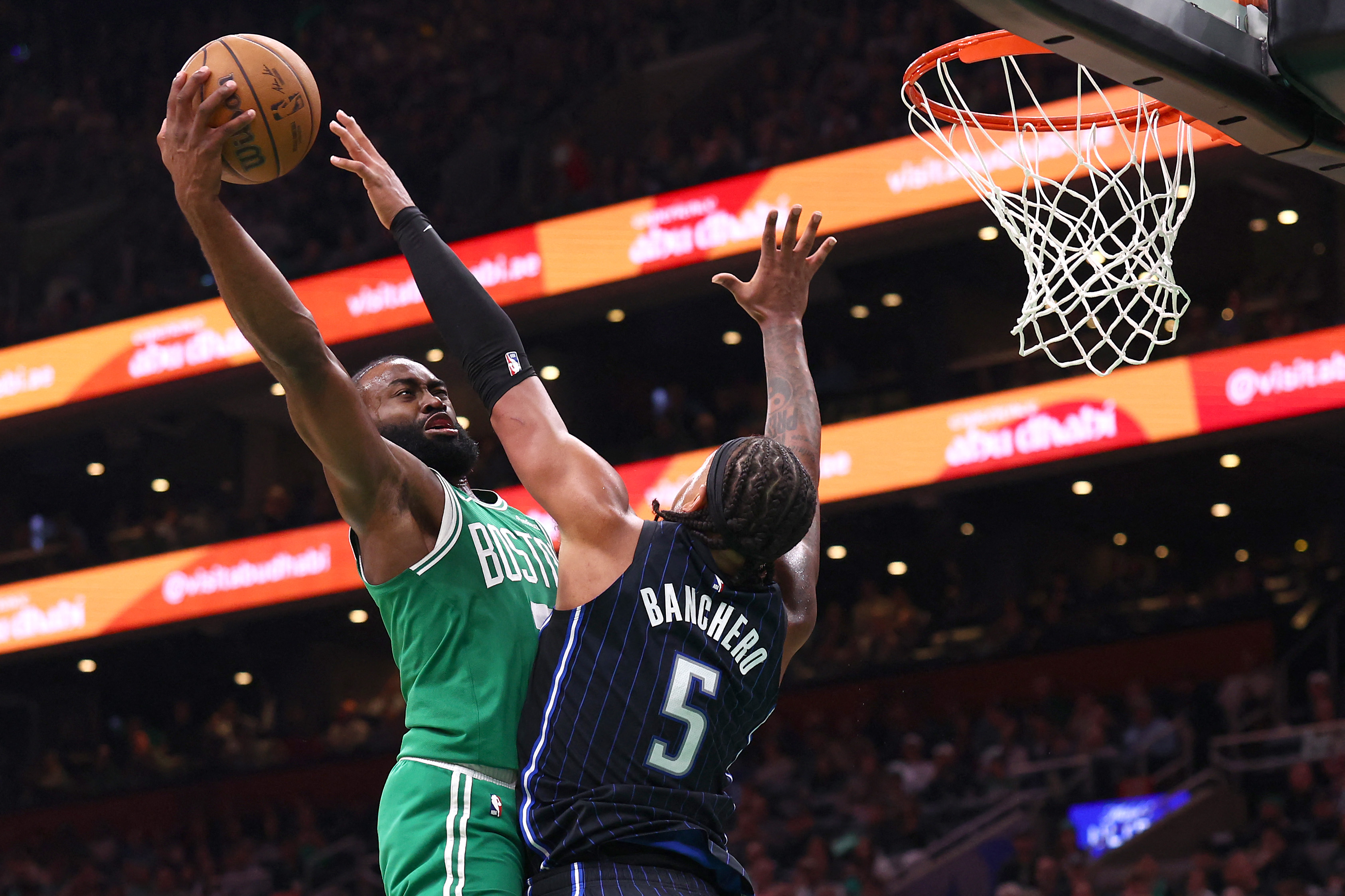 Jaylen Brown #7 of the Boston Celtics shoots the ball as Paolo Banchero #5 of the Orlando Magic defends.