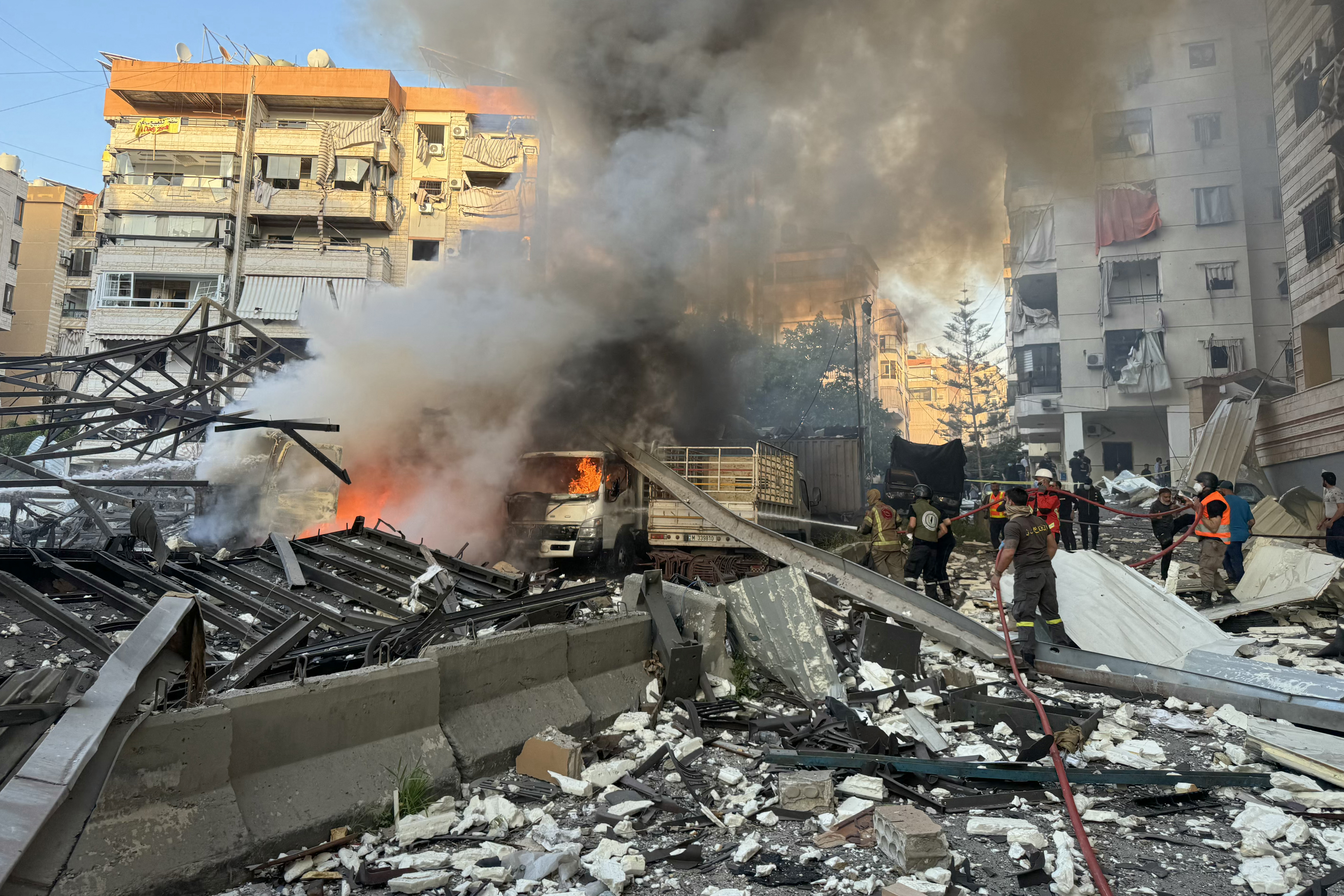 Lebanese rescuers extinguish a fire at a site hit by Israeli strikes following evacuation orders in Beirut's southern suburb on April 27, 2025.