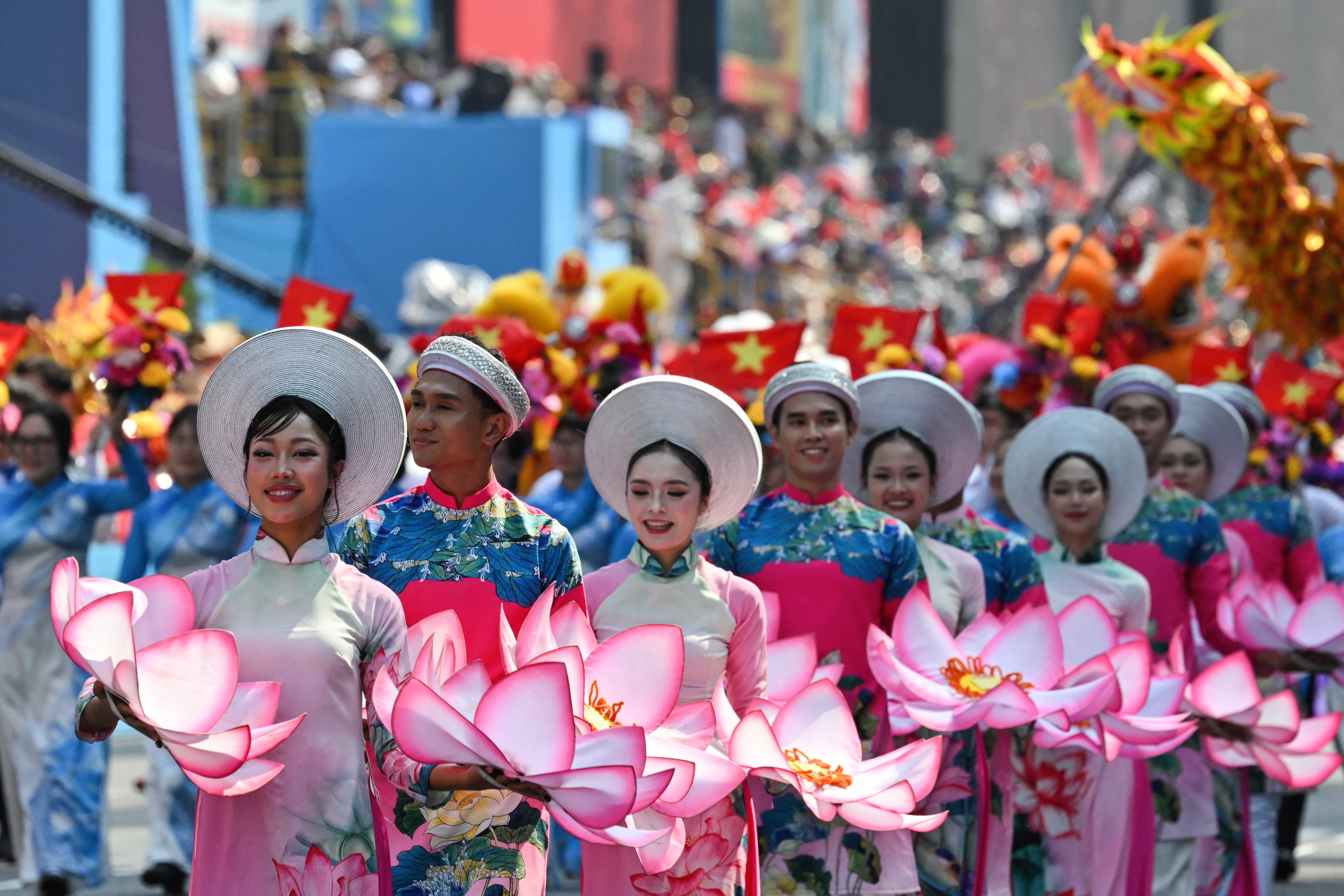 Participants march during a parade marking the 50th anniversary of the fall of Saigon and the end of the Vietnam War in Ho Chi Minh City on April 30, 2025. 
