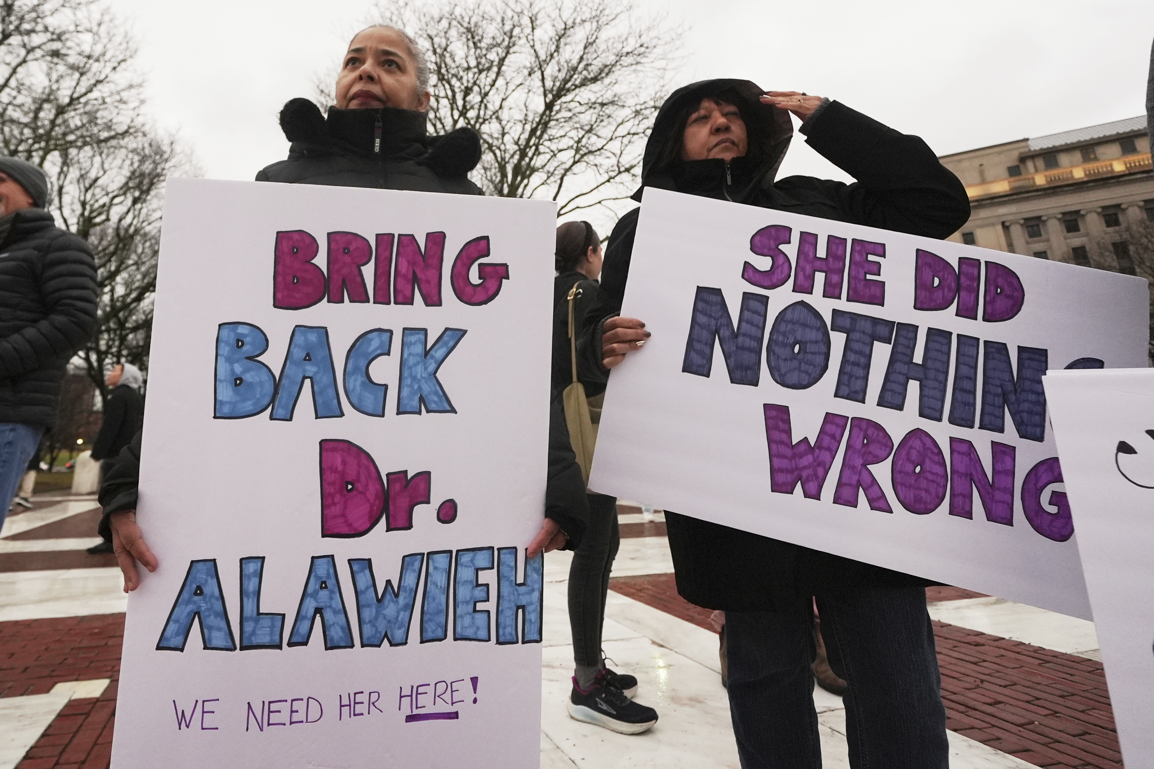 Protesters demonstrate outside in Rhode Island in defence of Rasha Alawieh with signs that read: "Bring back Dr Alawieh" and "She did nothing wrong"
