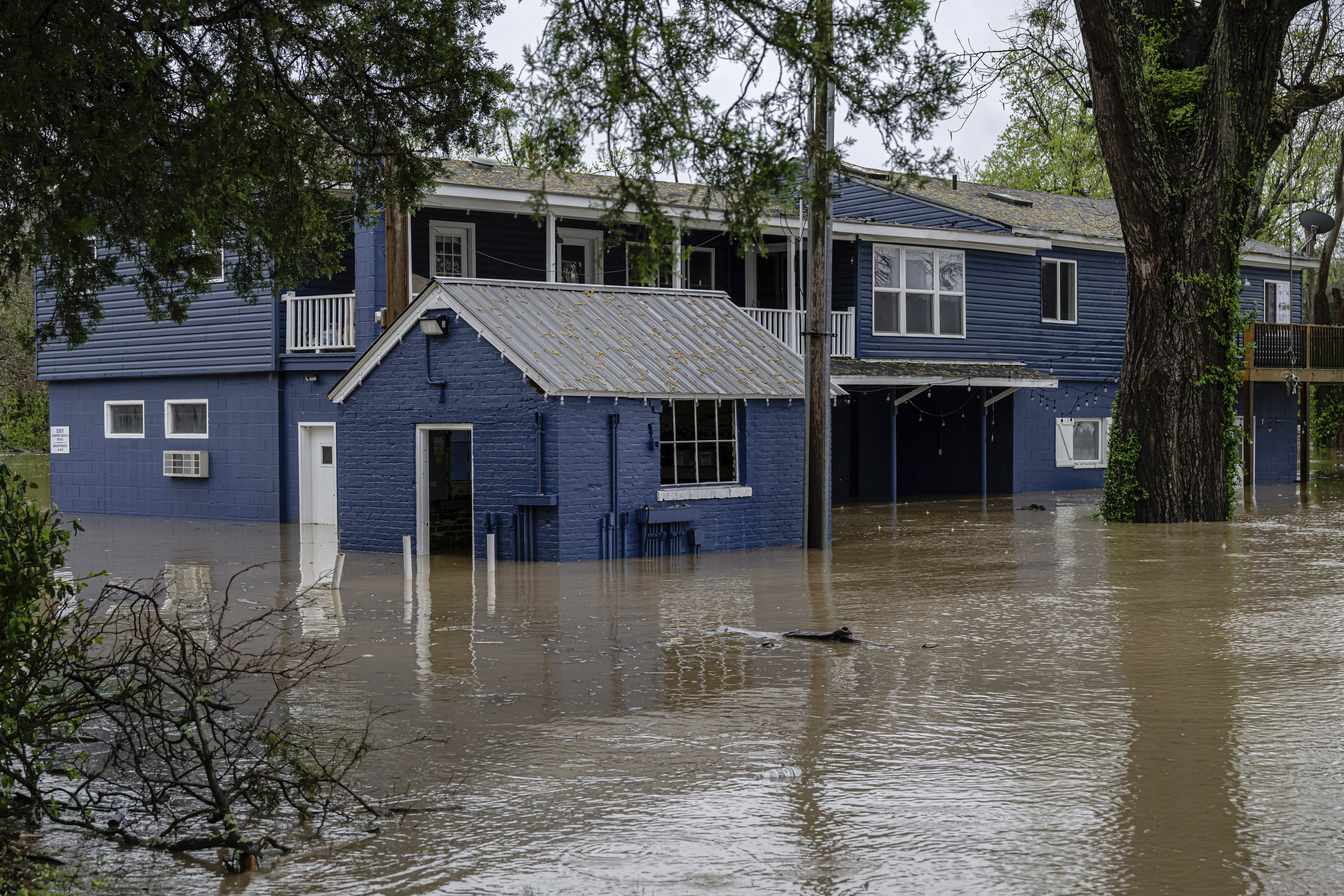 A flooded home is seen from the banks of the Ohio River