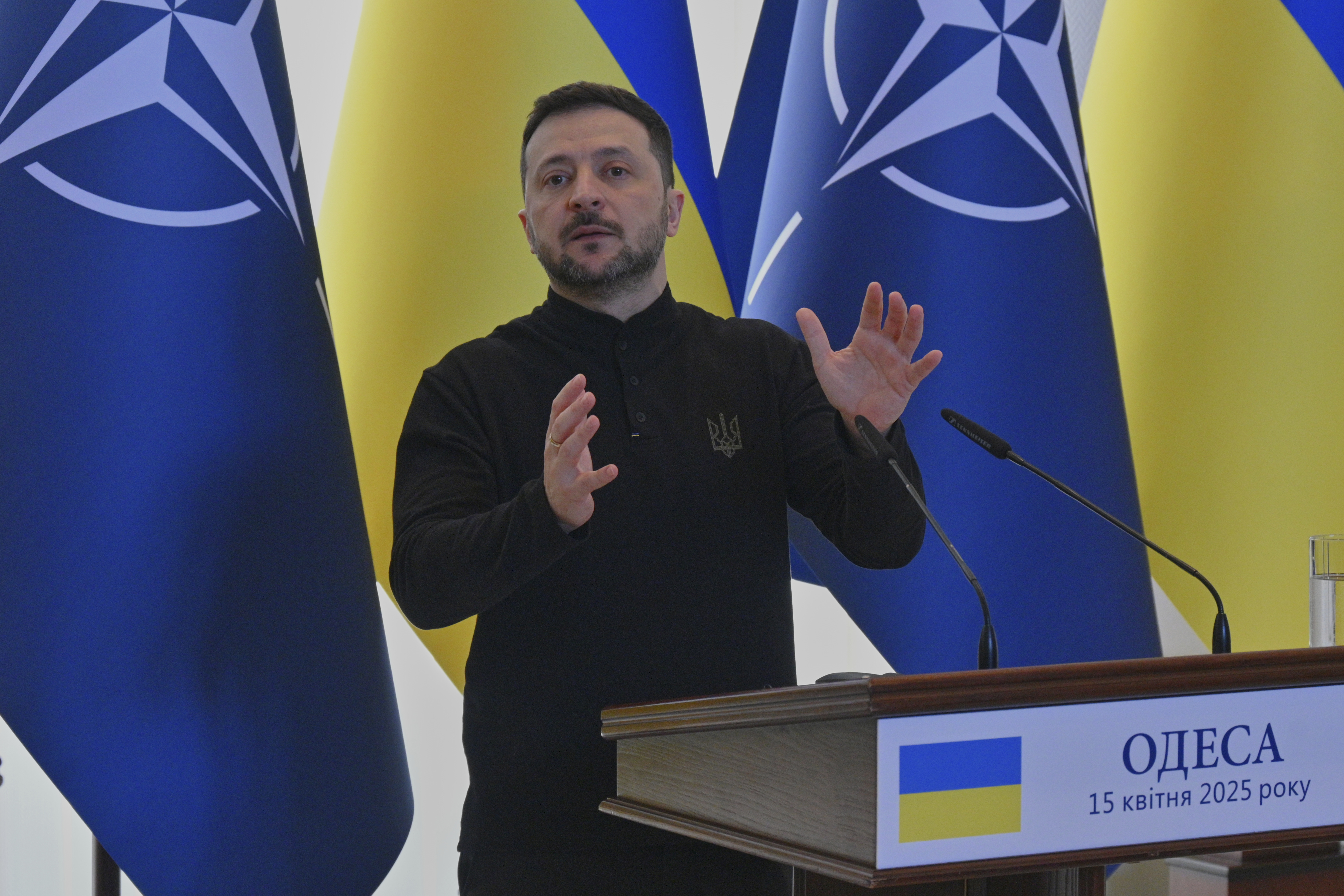 Zelenskyy speaks at a podium.
