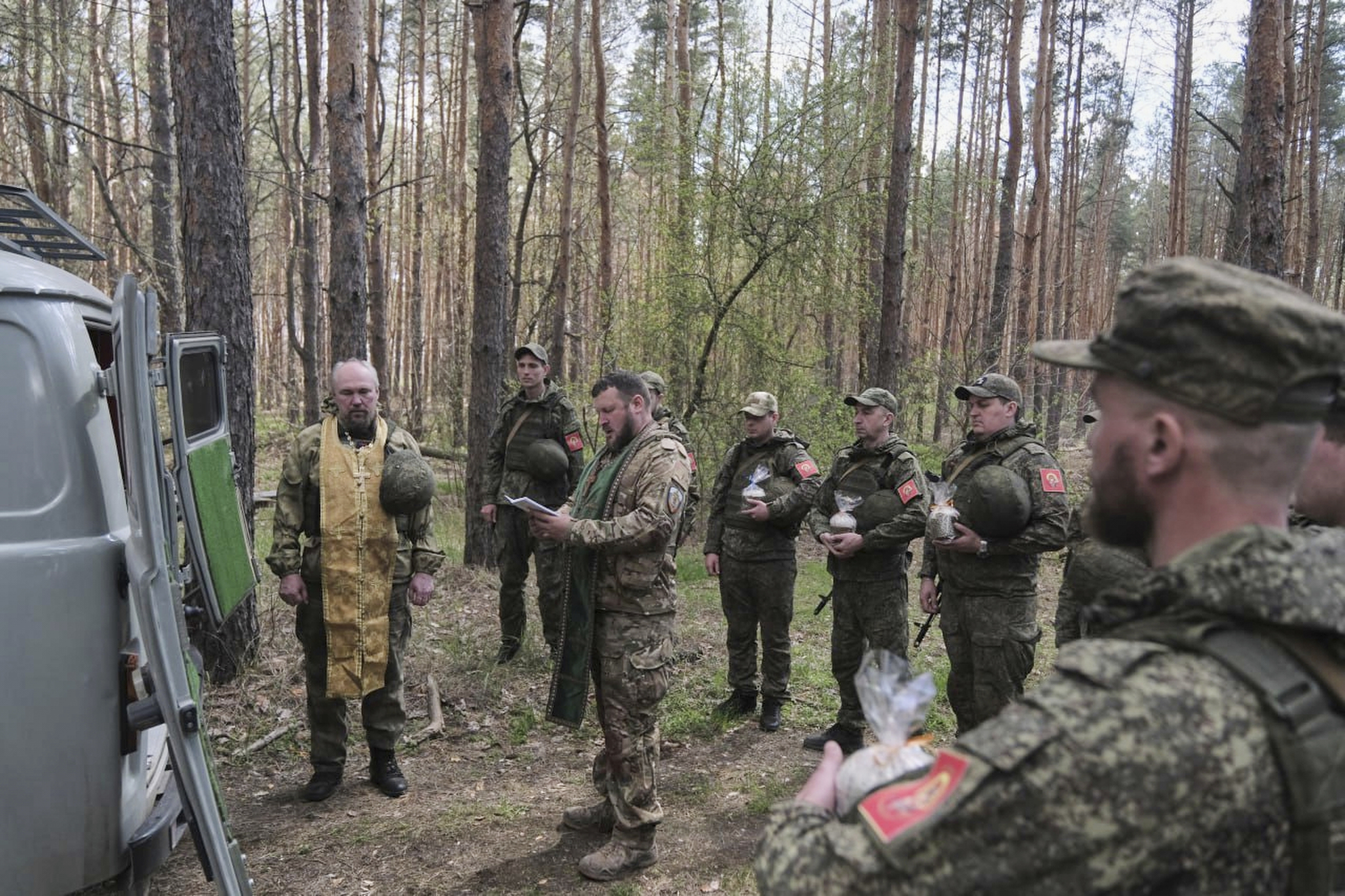 In this photo taken from video distributed by Russian Defense Ministry Press Service on Sunday, April 20, 2025, Russian soldiers attend a religion service on eve of Orthodox Easter at an unspecified location in Ukraine.