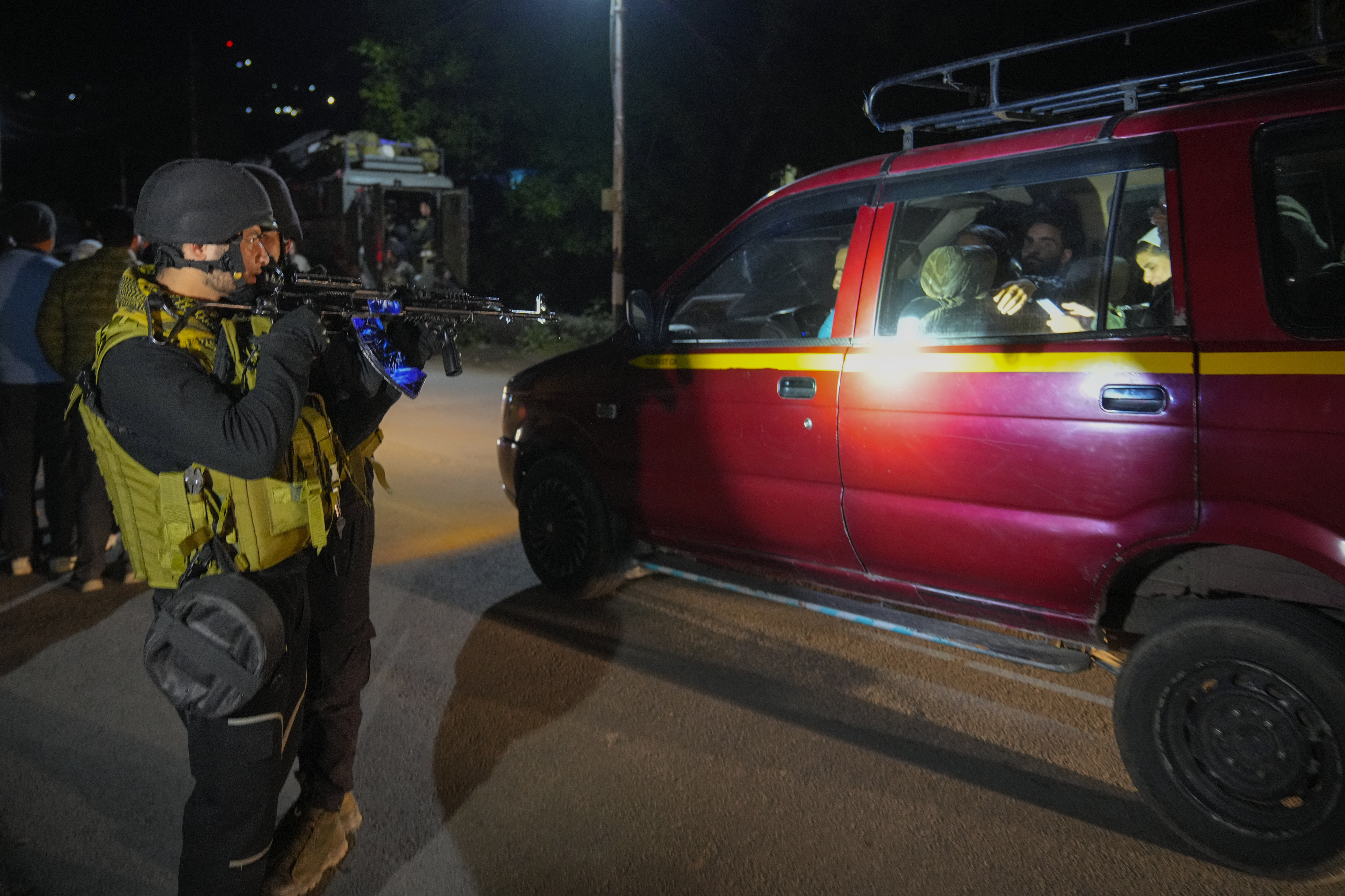 Indian police officers stand guard near Pahalgam in south Kashmir after assailants indiscriminately opened fired at tourists visiting Pahalgam, Indian controlled Kashmir, Tuesday, April 22, 2025.(AP Photo/Dar Yasin)