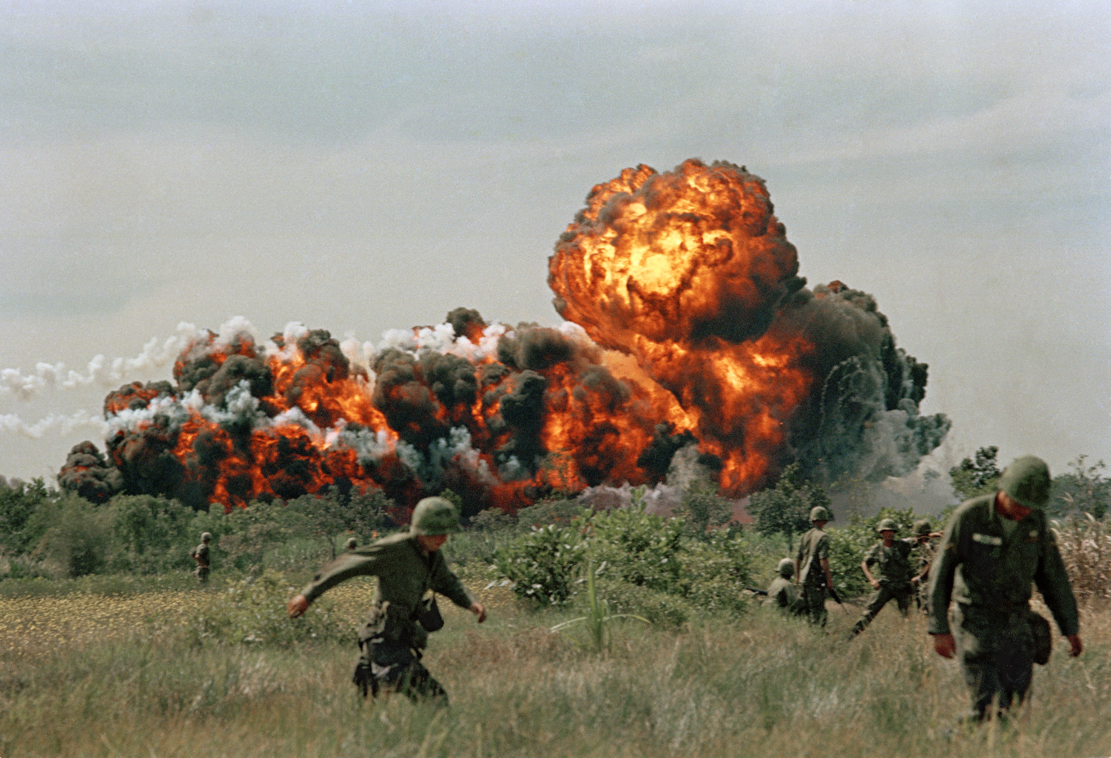 A napalm strike erupts in a fireball near U.S. troops on patrol in South Vietnam, 1966 during the Vietnam War. (AP Photo)