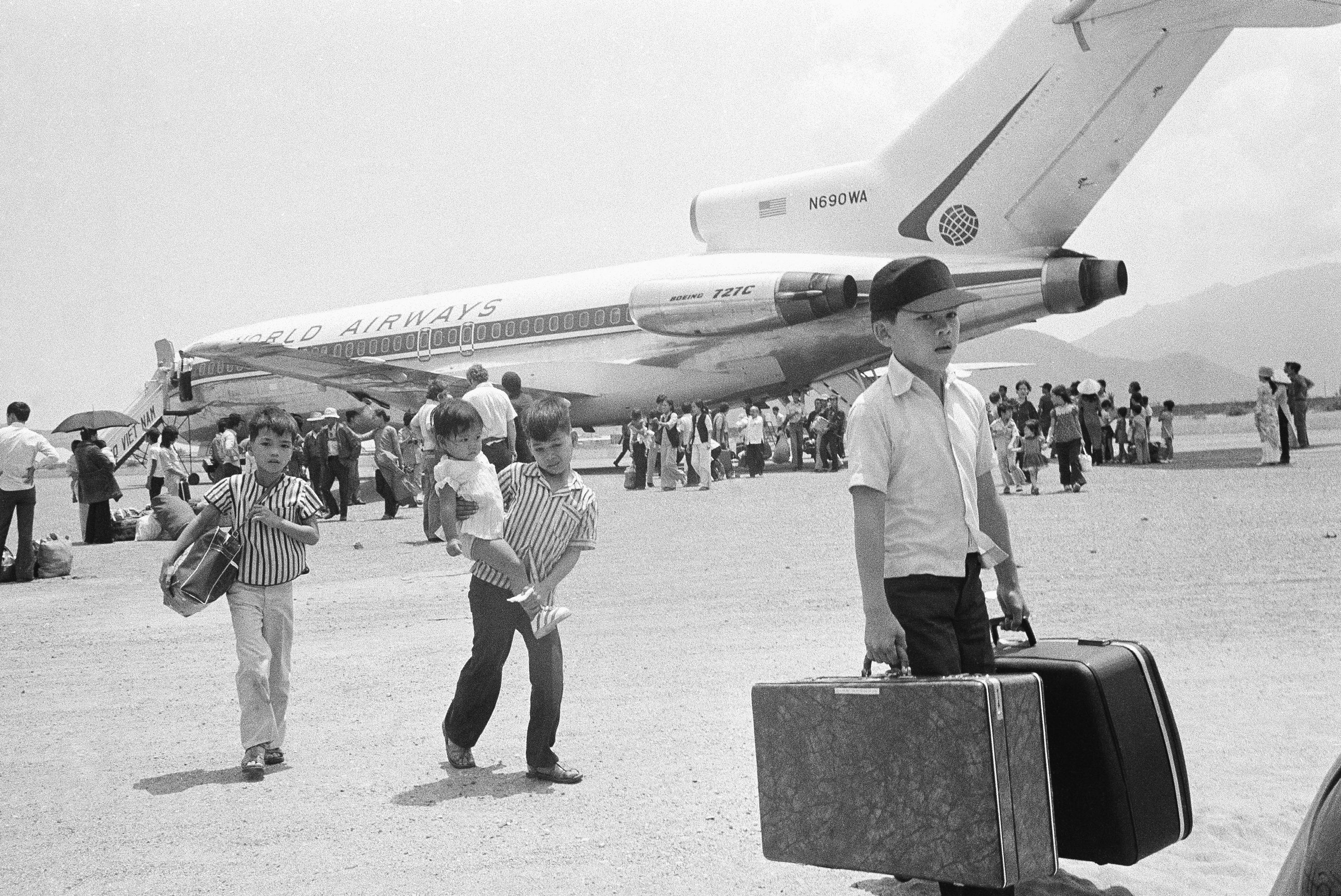 South Vietnamese refugee deplane at Nha Trang airfield in Vietnam, Thursday, March 27, 1975 following a jet hop from Danang as a U.S. financed airlift, using civilian chartered jets, relocates thousands of former residents of Hue. (AP Photo/Nick Ut)