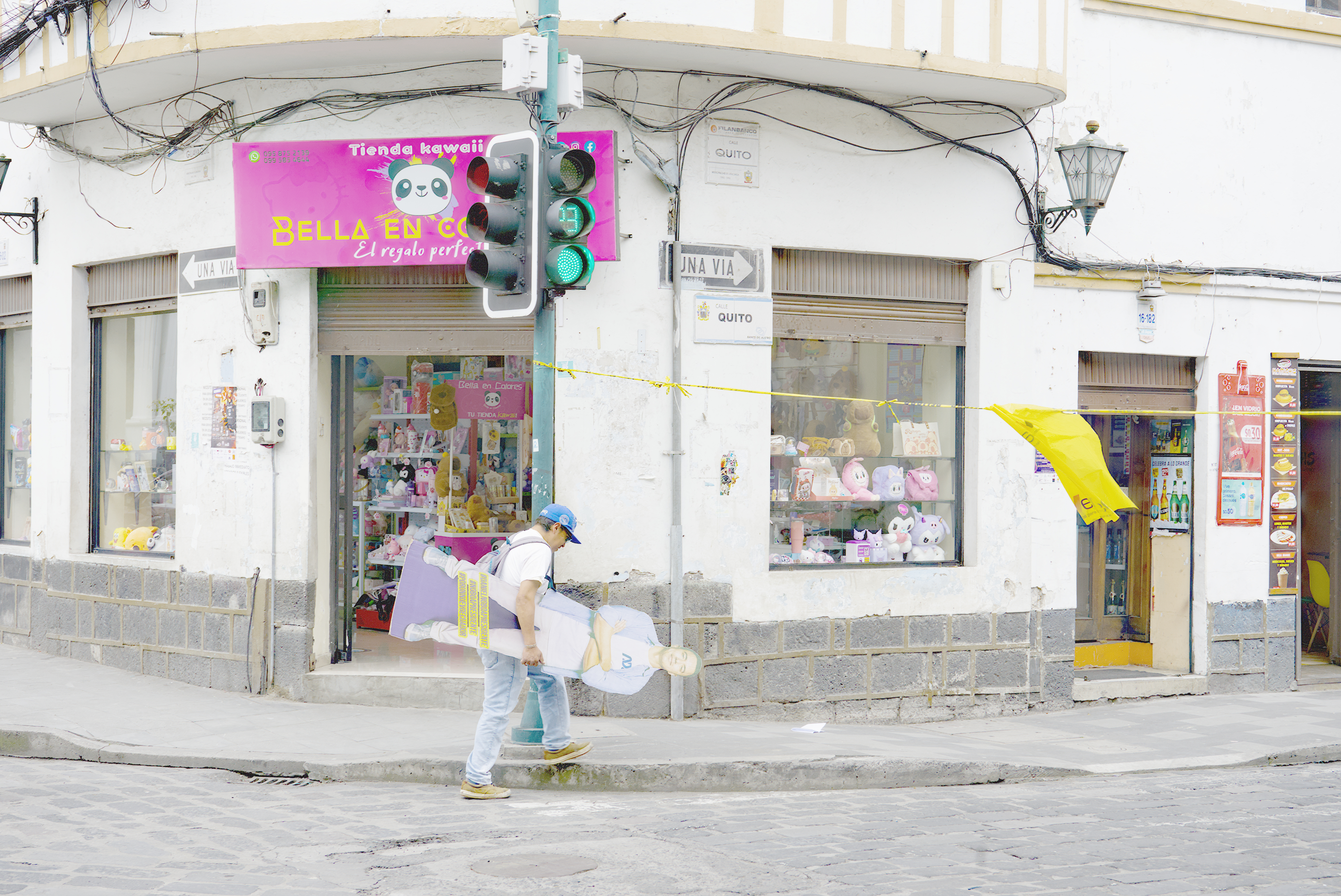 A man in Ecuador carries away a cardboard figure of Daniel Noboa