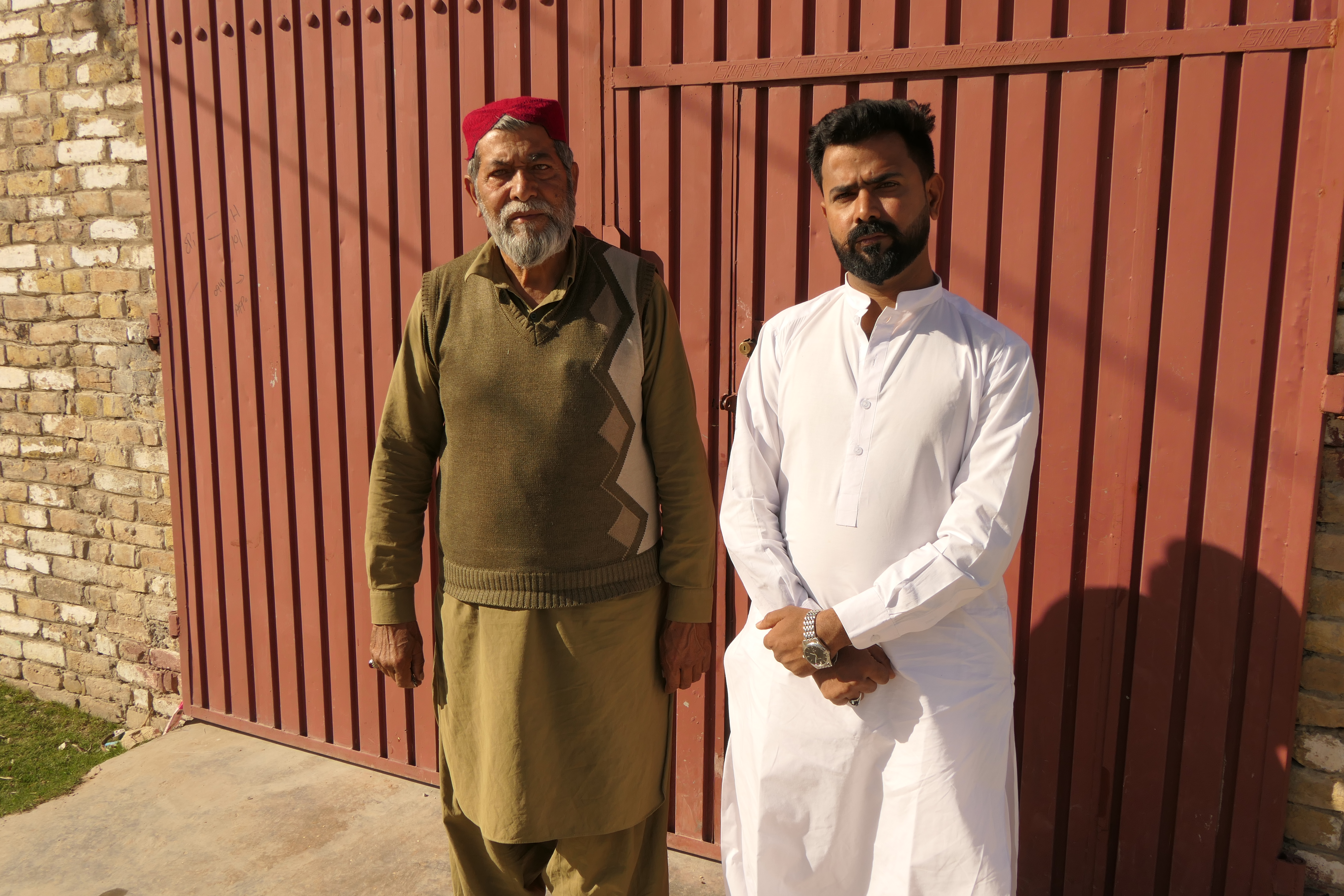 Saad and his father, also a former Pakistan railways driver, in front of their home in Quetta, Pakistan [Saadullah Akhter/Al Jazeera]