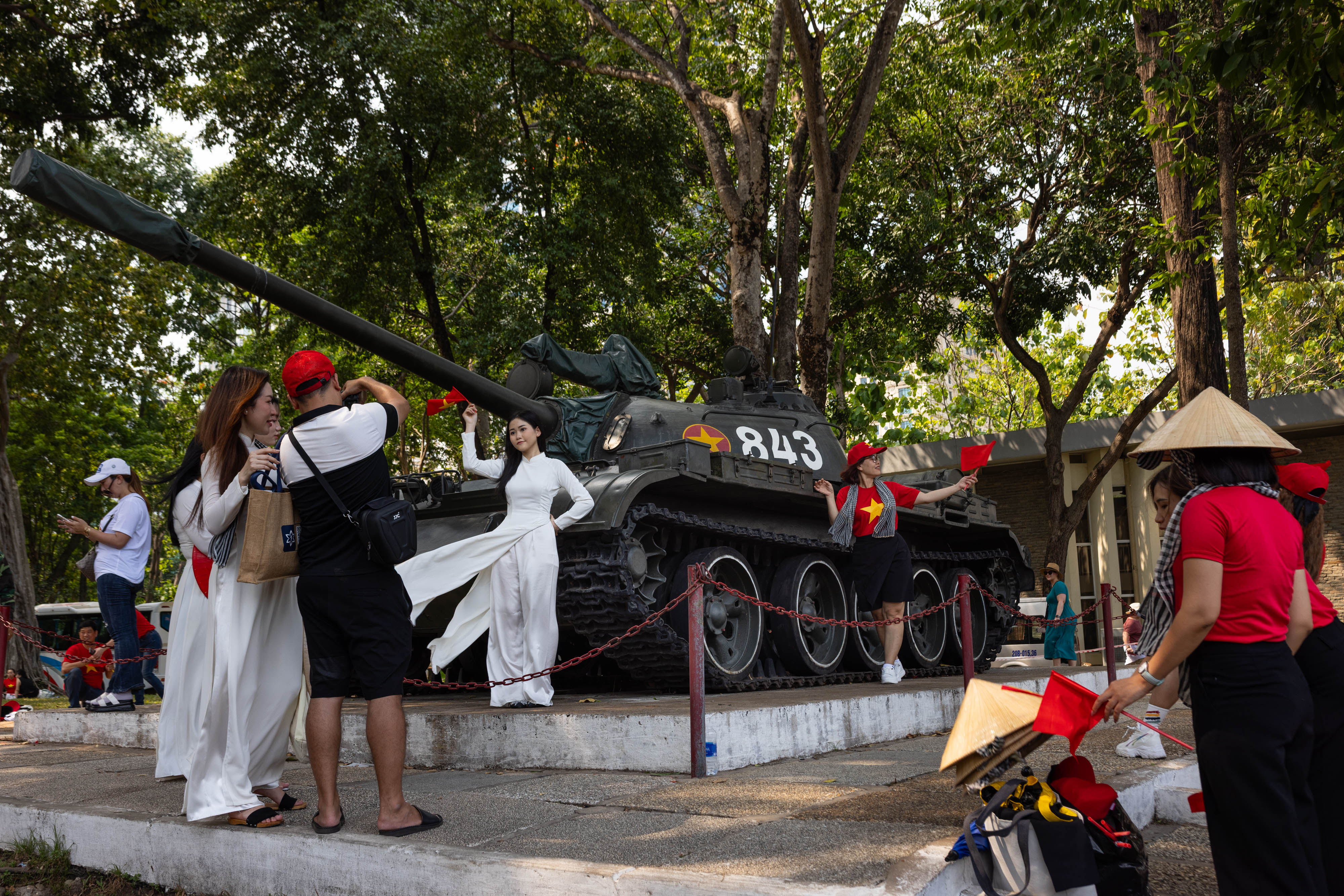 People take photos in front of the former presidential building of the Republic of Vietnam (South Vietnam), now a historical landmark renamed to Independence Palace, ahead of upcoming Liberation Day celebrations, in Ho Chi Minh City, VIetnam, on April 28, 2025. Photo by Chris Trinh