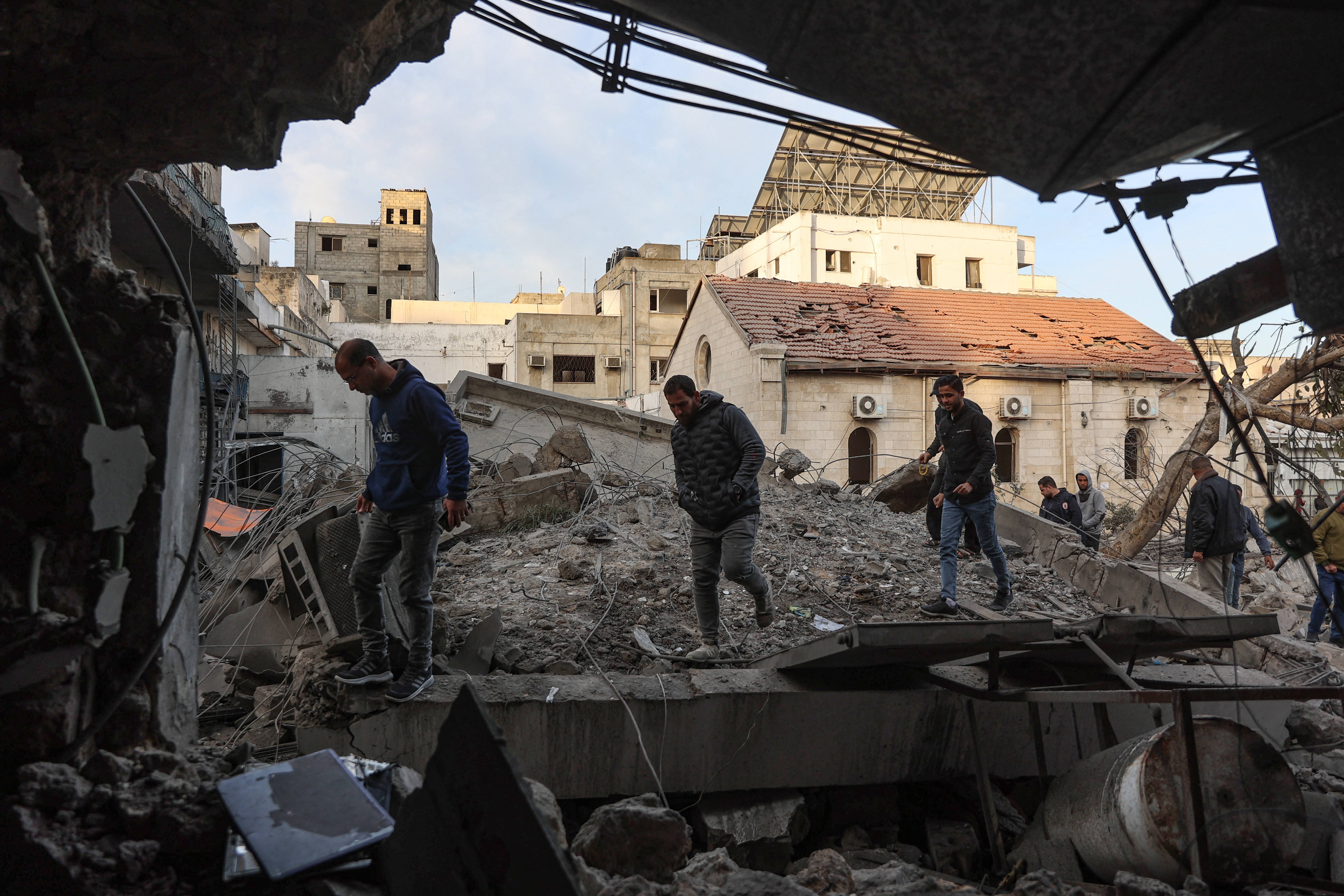 People check the destruction in the aftermath of an Israeli strike on the Al-Ahli hospital, also known as the Baptist or Ahli Arab hospital, in Gaza City on April 13, 2025.