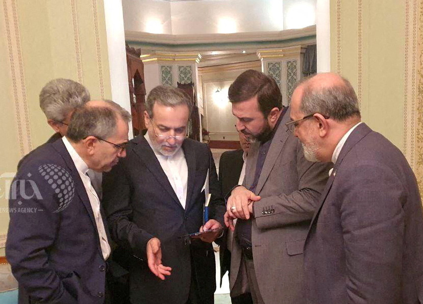 FILE PHOTO: Iranian Foreign Minister Abbas Araqchi speaks with members of his delegation after talks with the US in Muscat, Oman, April 12, 2025. KhabarOnline/WANA (West Asia News Agency)/ Handout via REUTERS ATTENTION EDITORS - THIS PICTURE WAS PROVIDED BY A THIRD PARTY. WATERMARK FROM SOURCE/File Photo