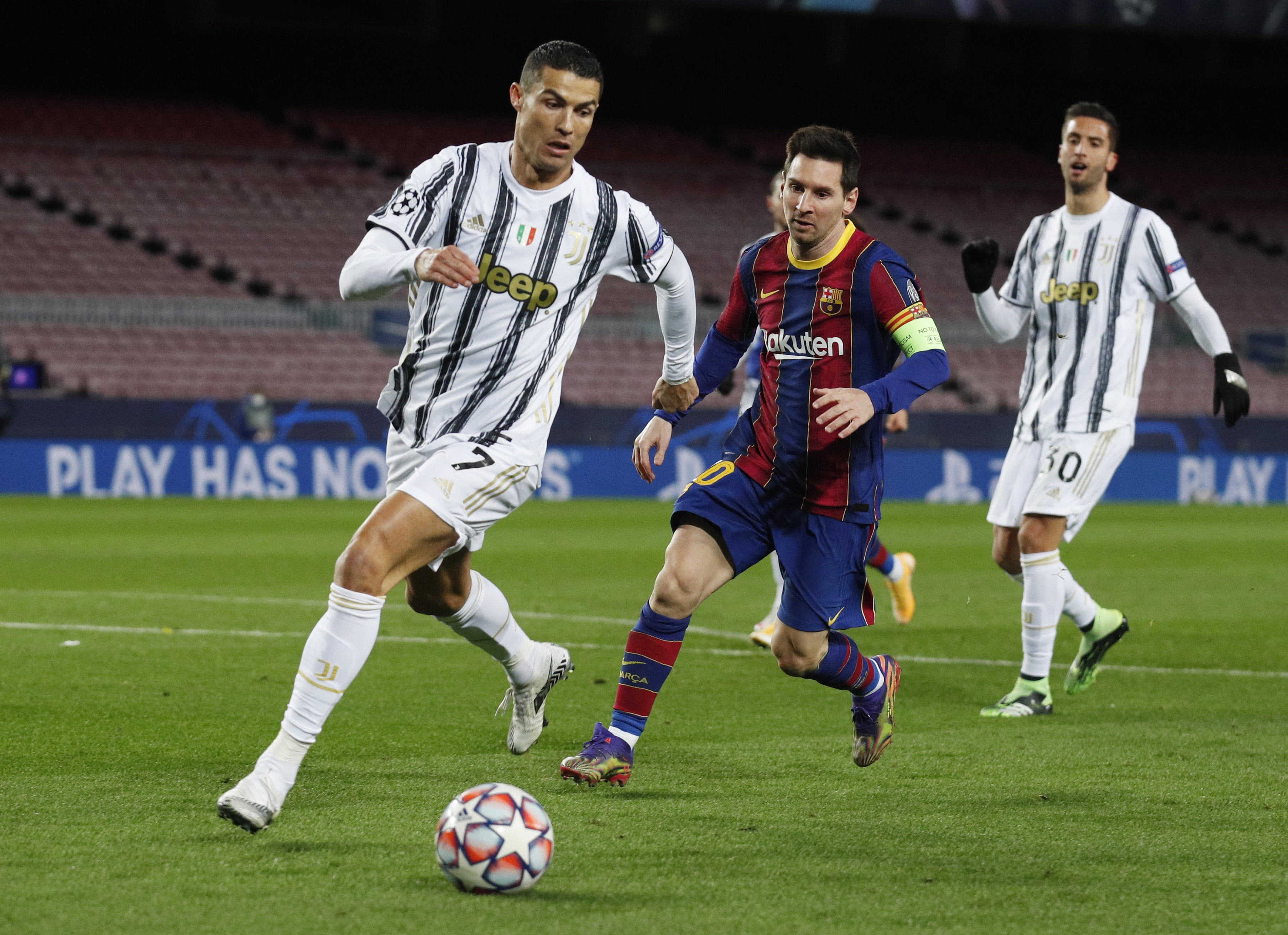 Barcelona's Lionel Messi in action with Juventus' Cristiano Ronaldo