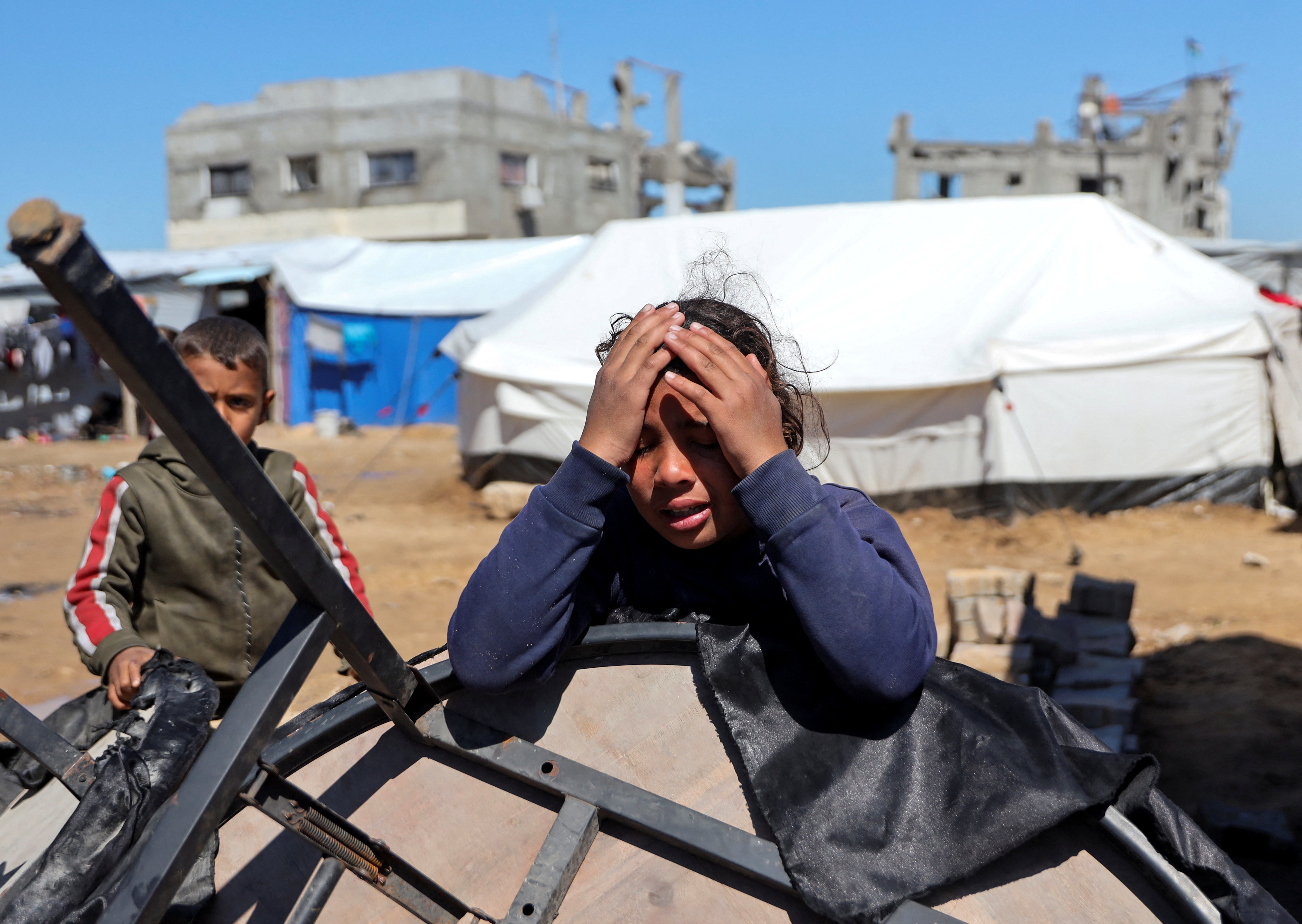 A Palestinian child reacts during a funeral in Gaza