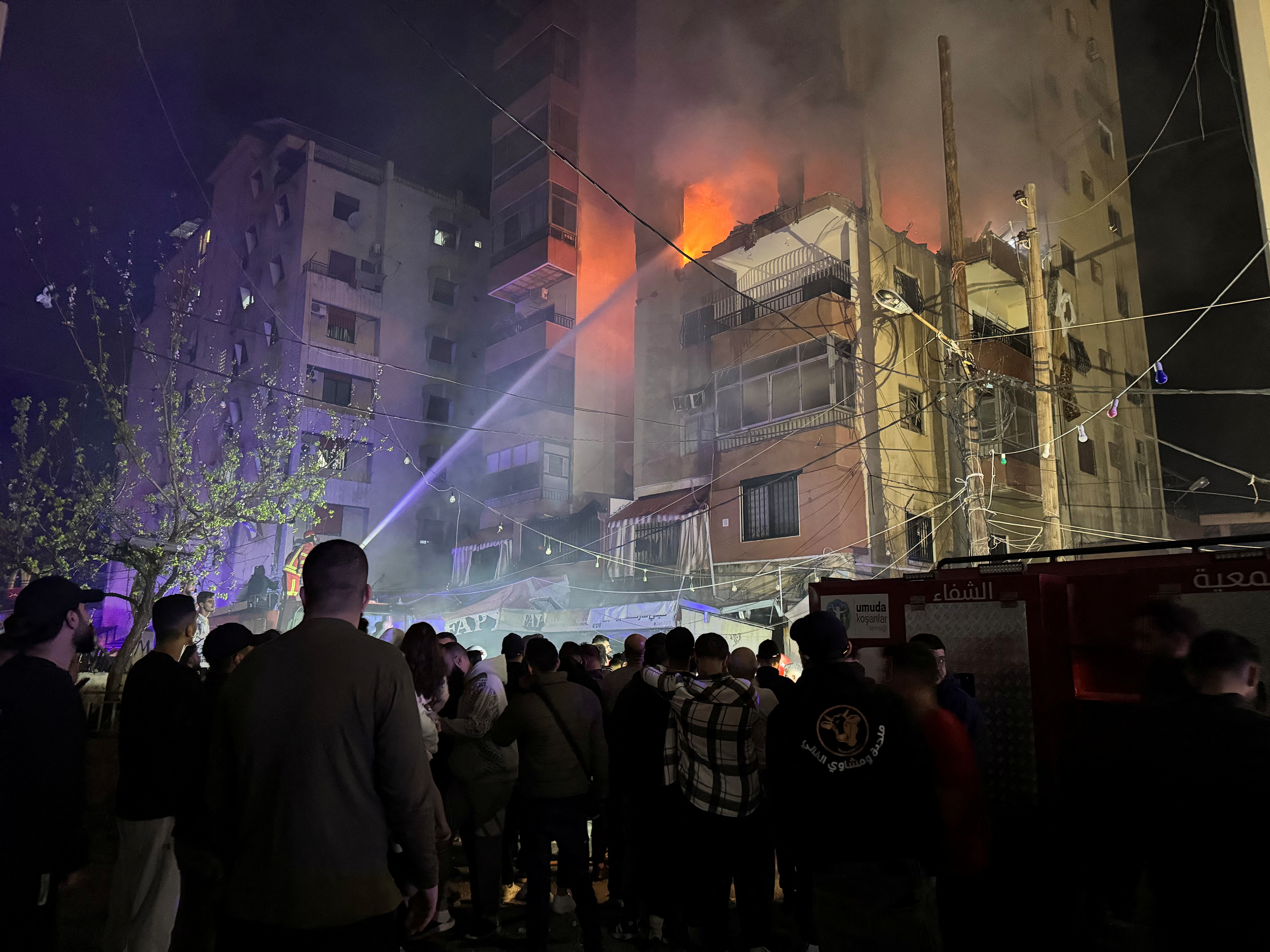 Firefighters try to put out a fire at a building.