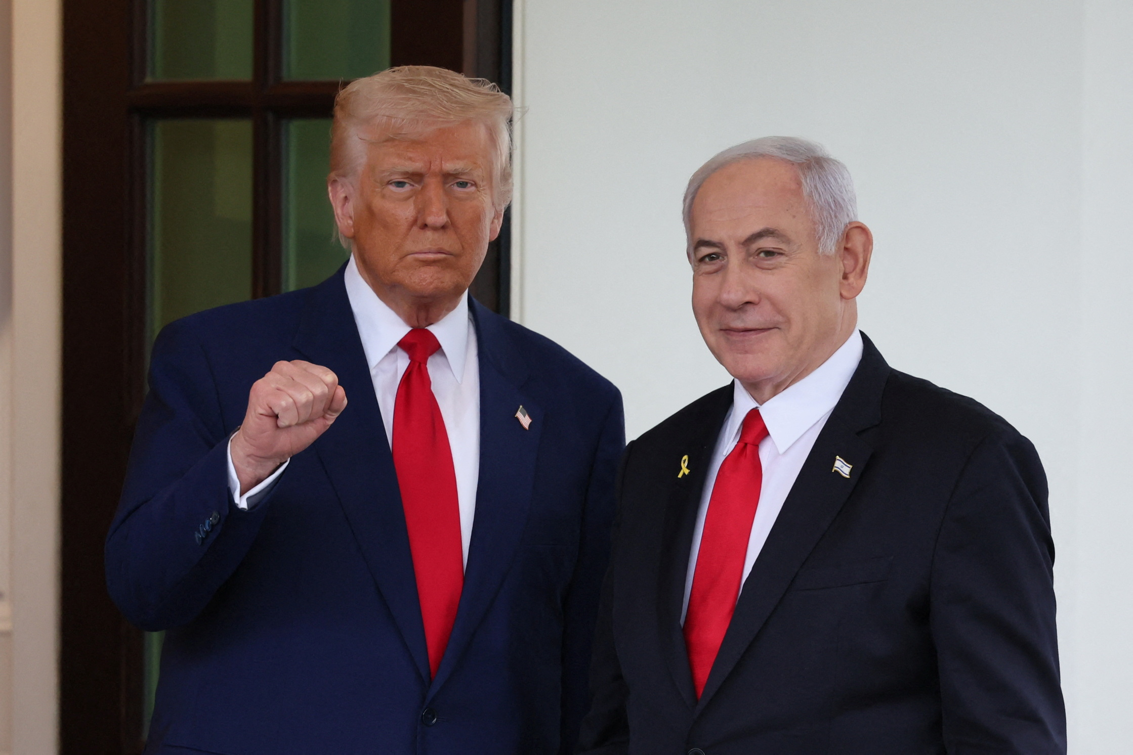US President Donald Trump welcomes Israeli Prime Minister Benjamin Netanyahu at the entrance of the White House