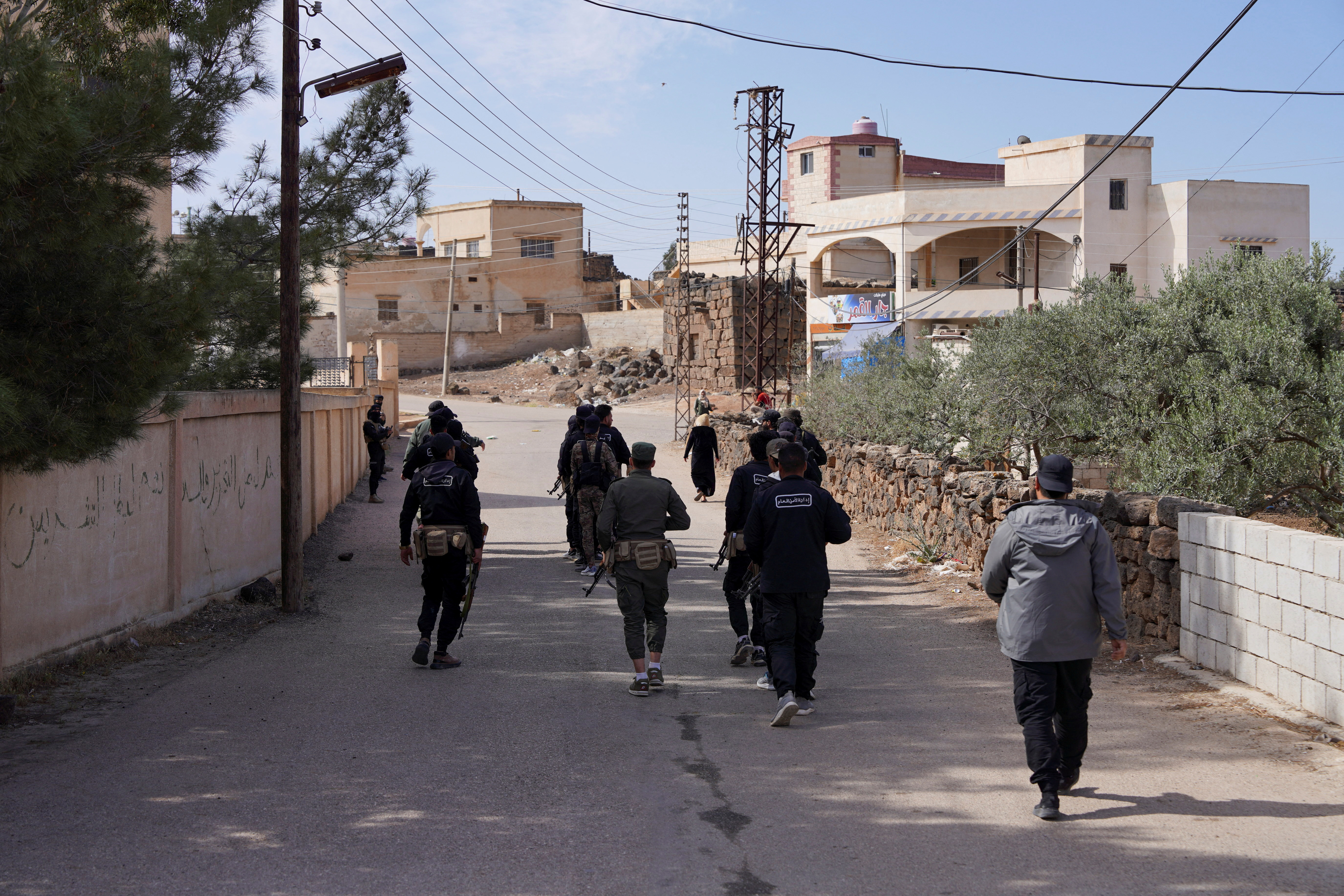 Members of Syrian security forces patrol.