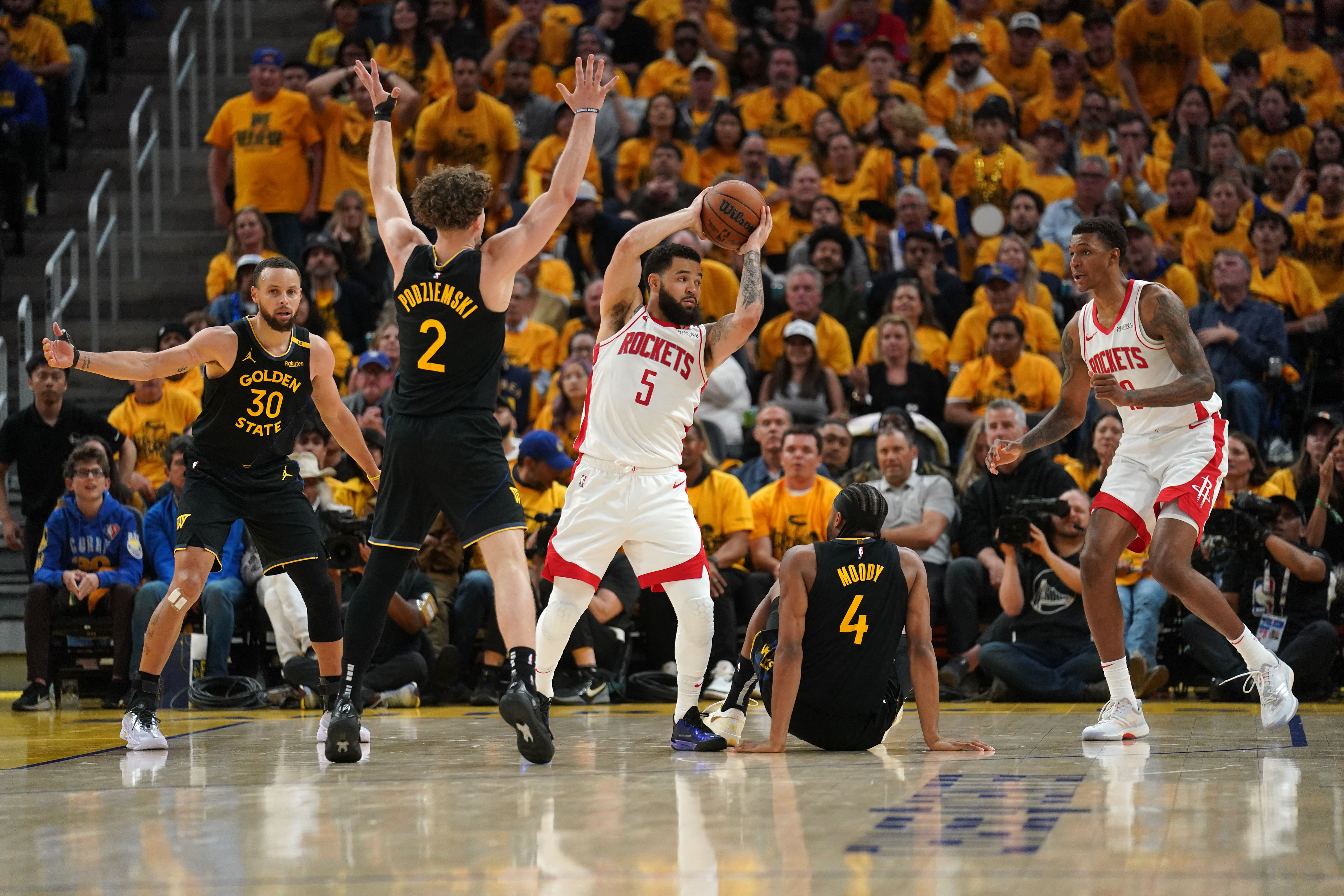May 2, 2025; San Francisco, California, USA; Houston Rockets guard Fred VanVleet (5) holds onto the ball next to Golden State Warriors guard Stephen Curry (30), guard Brandin Podziemski (2) and guard Moses Moody (4) in the third quarter of game six of the first round for the 2025 NBA Playoffs at Chase Center. Mandatory Credit: Cary Edmondson-Imagn Images