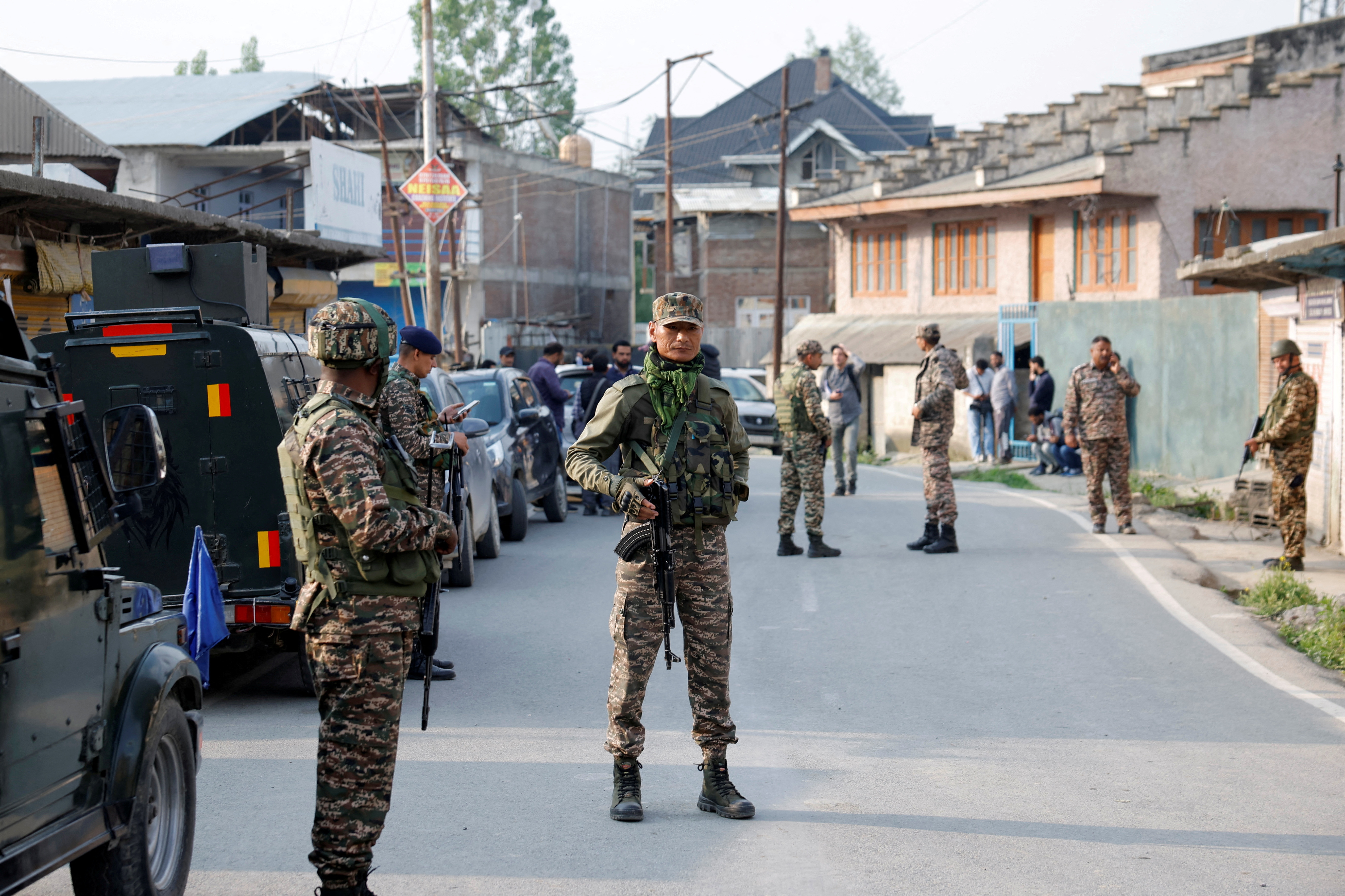 Indian security force personnel stand guard near the site of a fighter jet crash in Wuyan in India-administered Kashmir's Pulwama