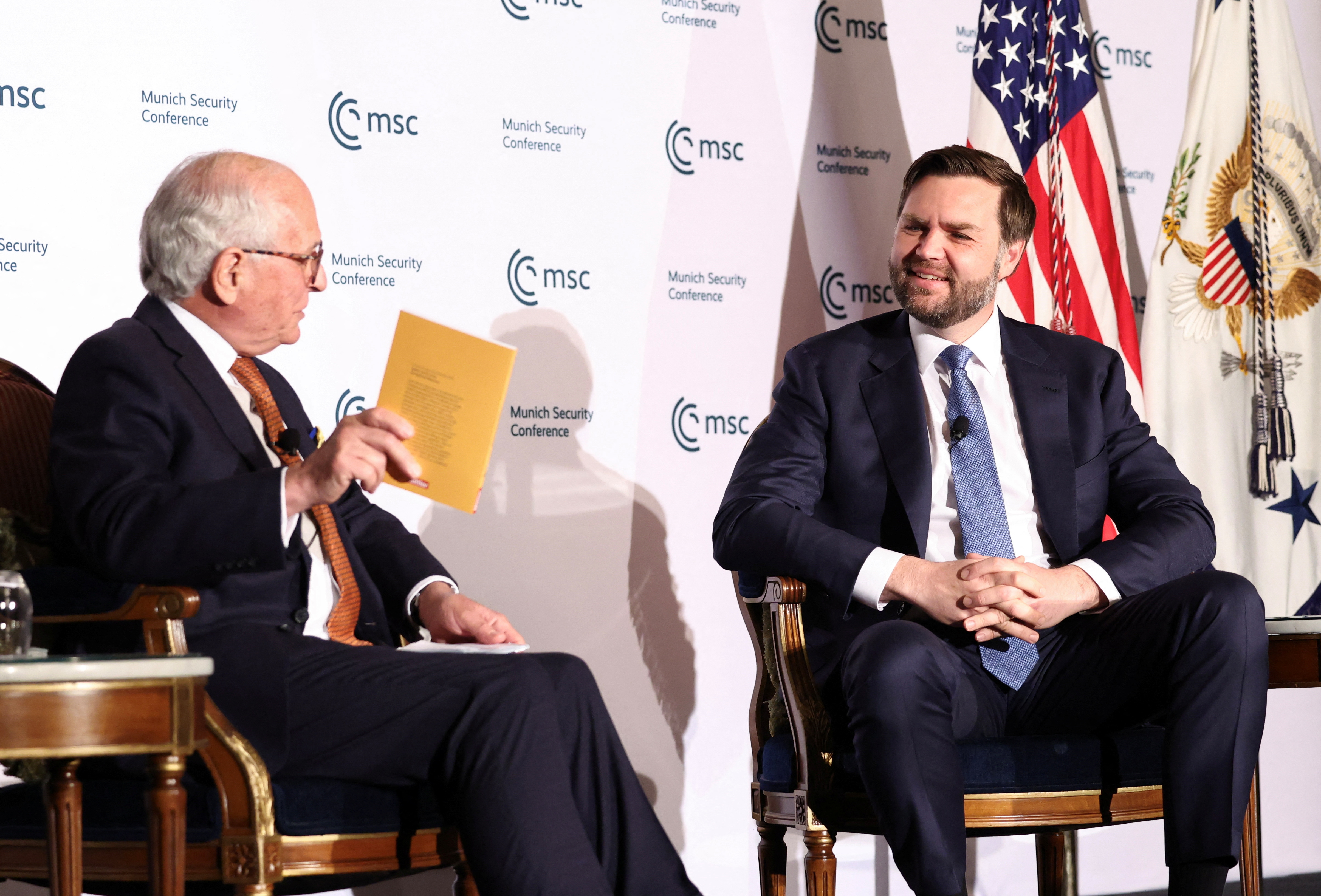 Wolfgang Ischinger is seated across from JD Vance, as they speak to one another on stage at the Munich leaders' meeting.