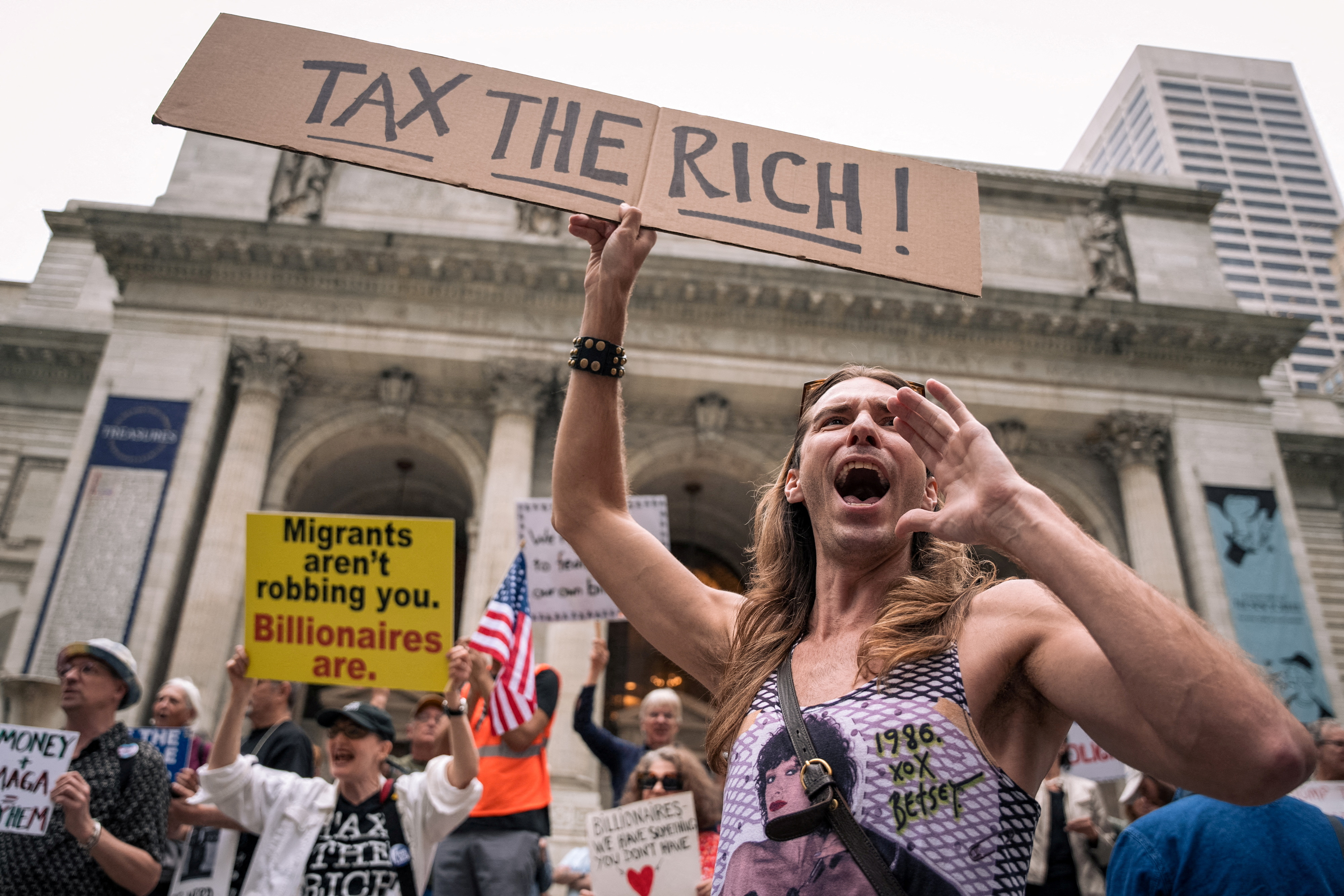 Protestors shout during a demonstration against the Trump administration and billionaire class outside the New York Public Library in Midtown in New York City