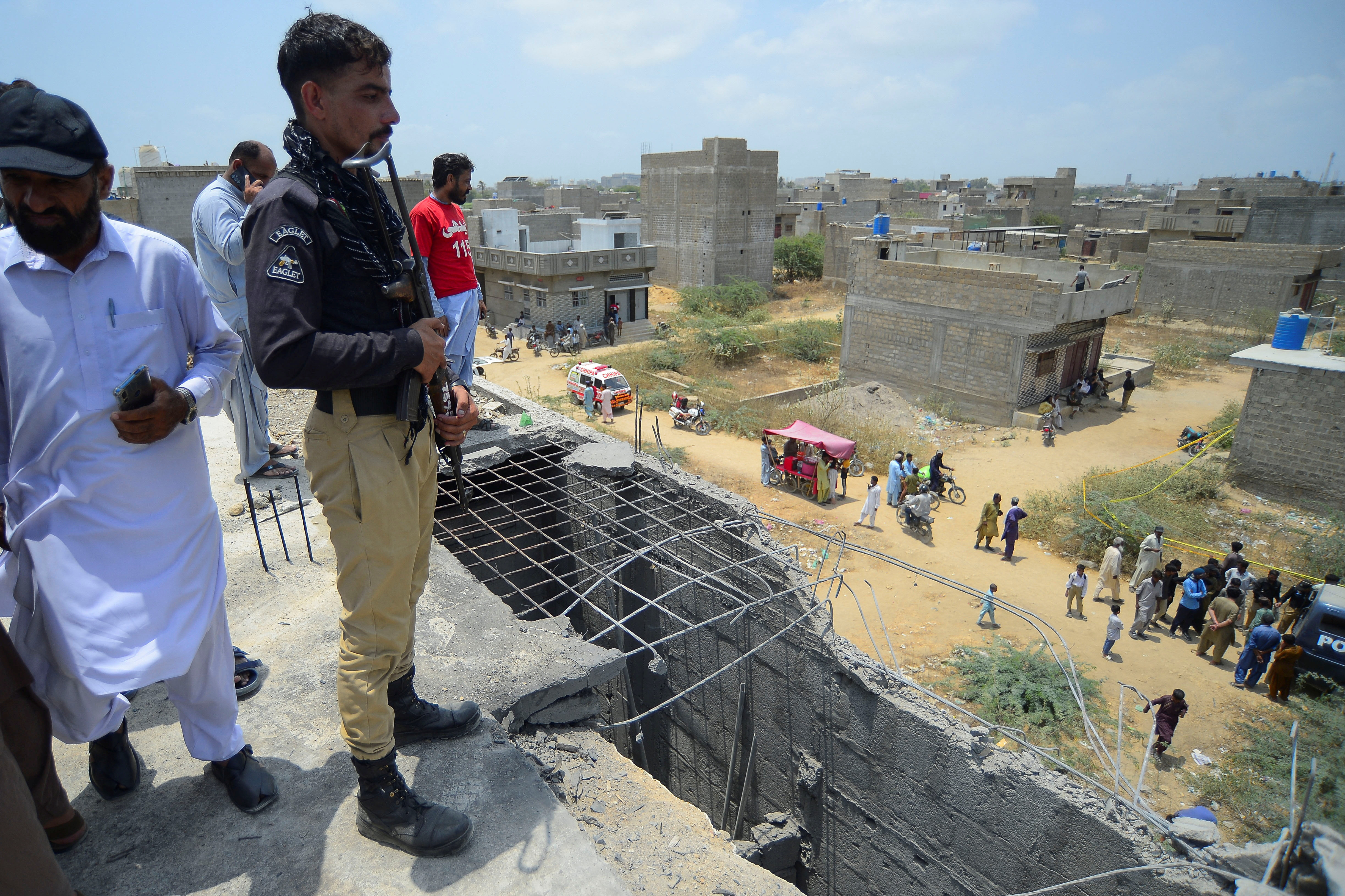 A police officer stands at the site where according to the Crime Scene Unit (CSU), a drone was brought down, on the outskirts of Karachi, Pakistan May 8, 2025. REUTERS/Imran Ali