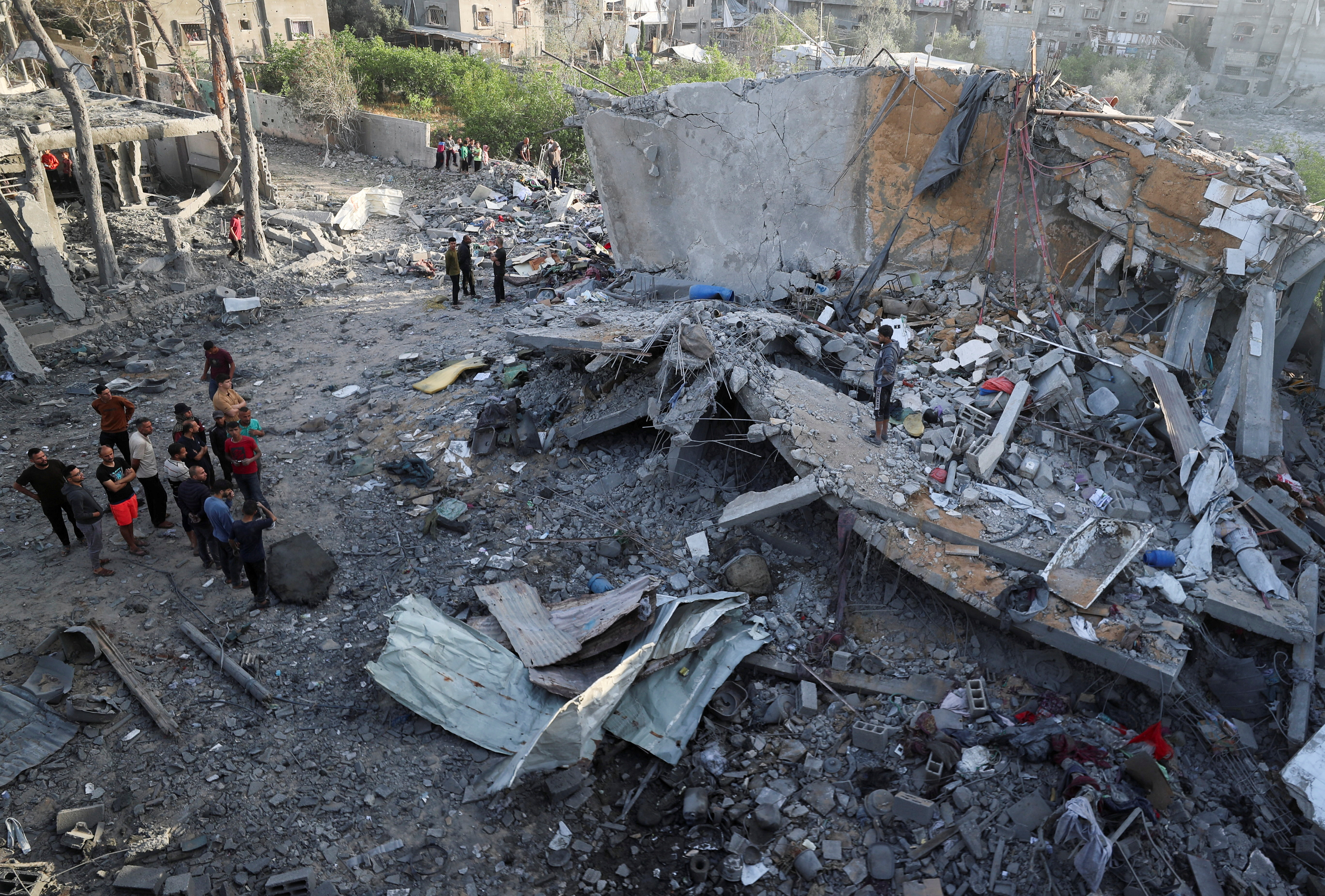 Palestinians inspect the site of an Israeli strike on a house, in Jabalia, in the northern Gaza Strip,