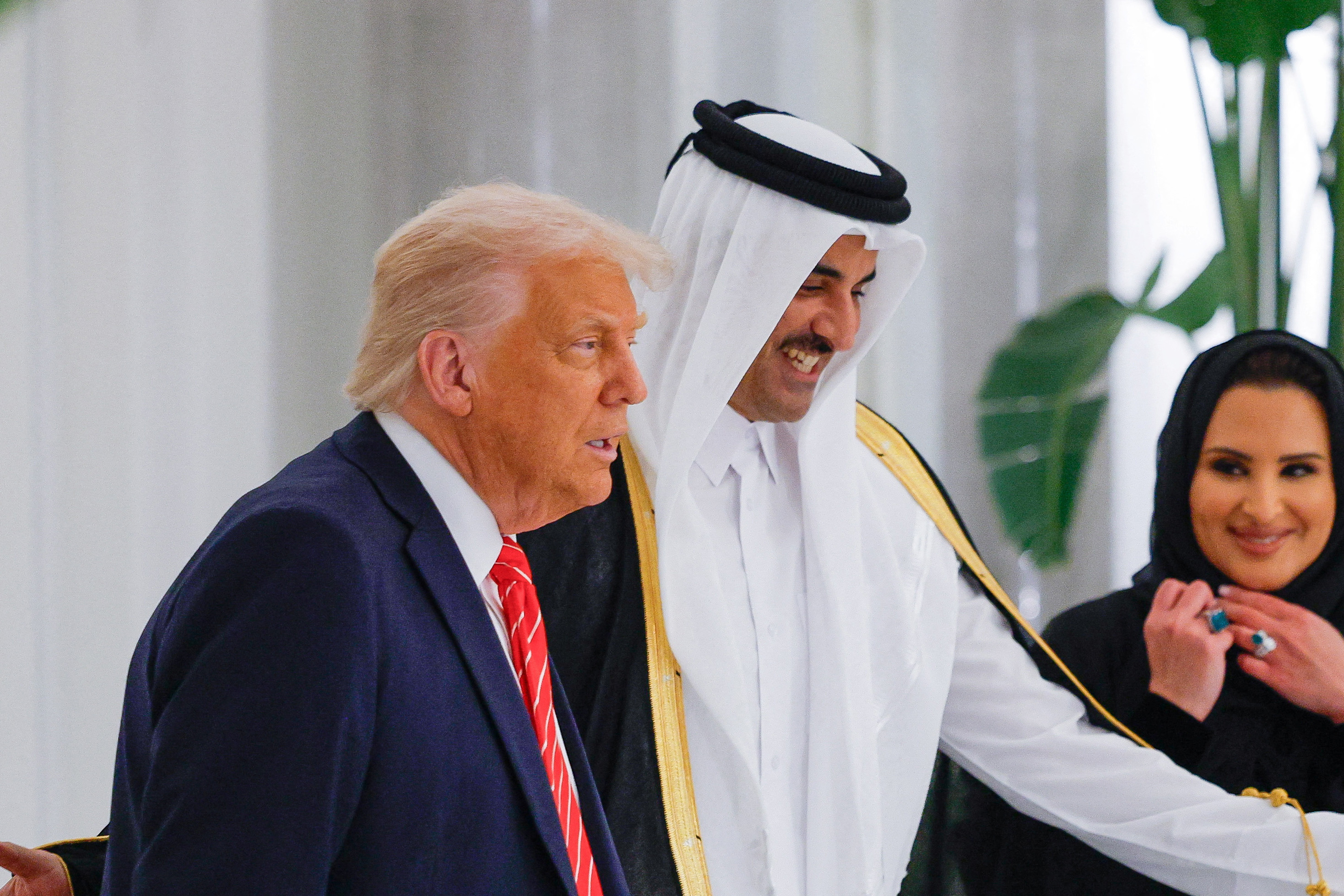 U.S. President Donald Trump walks with Qatar's Emir Tamim bin Hamad Al Thani