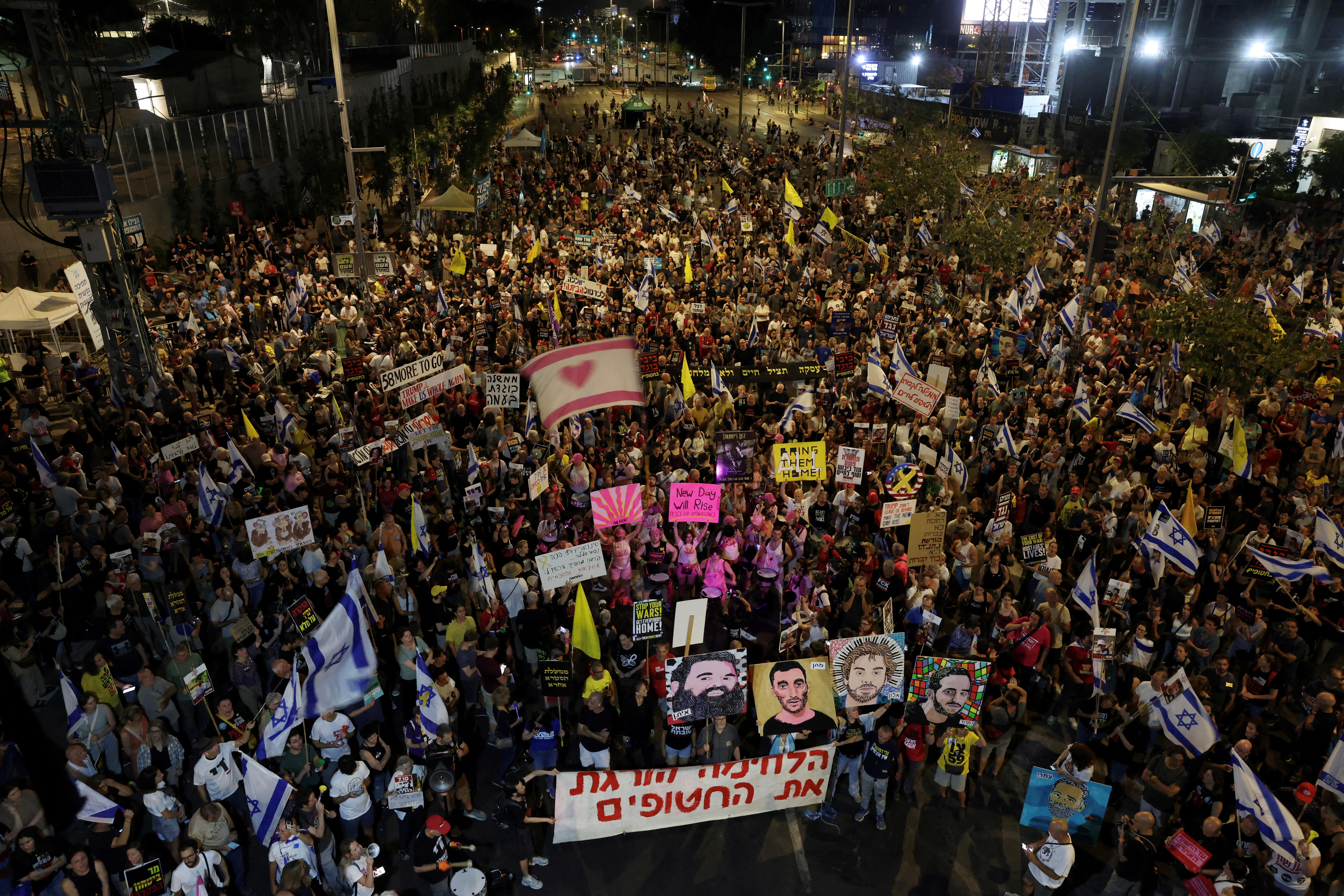 Demonstrators hold a banner that reads "The fighting kills the Hostages".