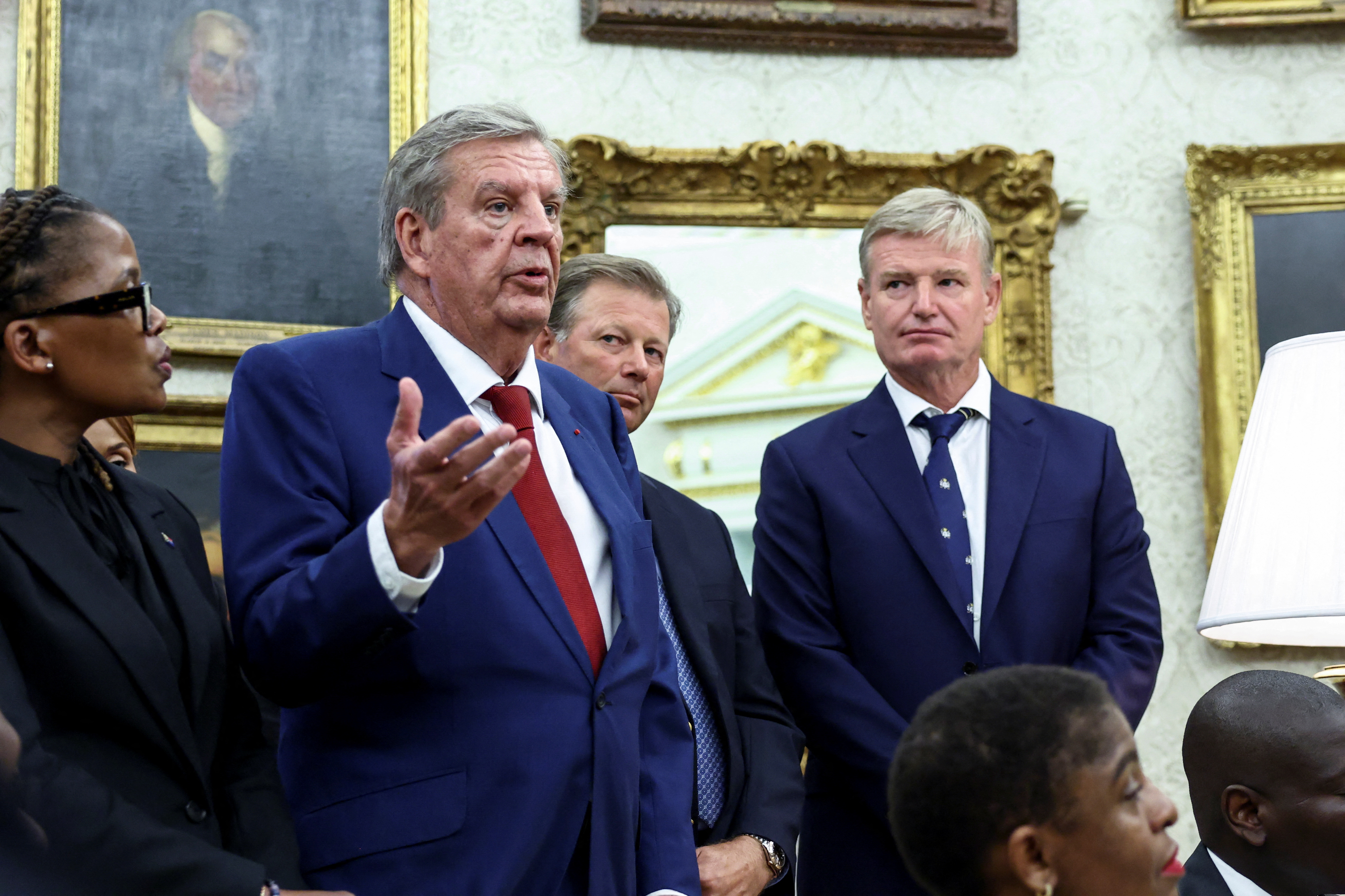 Businessman Johann Rupert speaks next to Golfers Retief Goosen and Ernie Els in the Oval Office, during a meeting between U.S. President Donald Trump and South African President Cyril Ramaphosa, at the White House in Washington, D.C., U.S., May 21, 2025. REUTERS/Kevin Lamarque