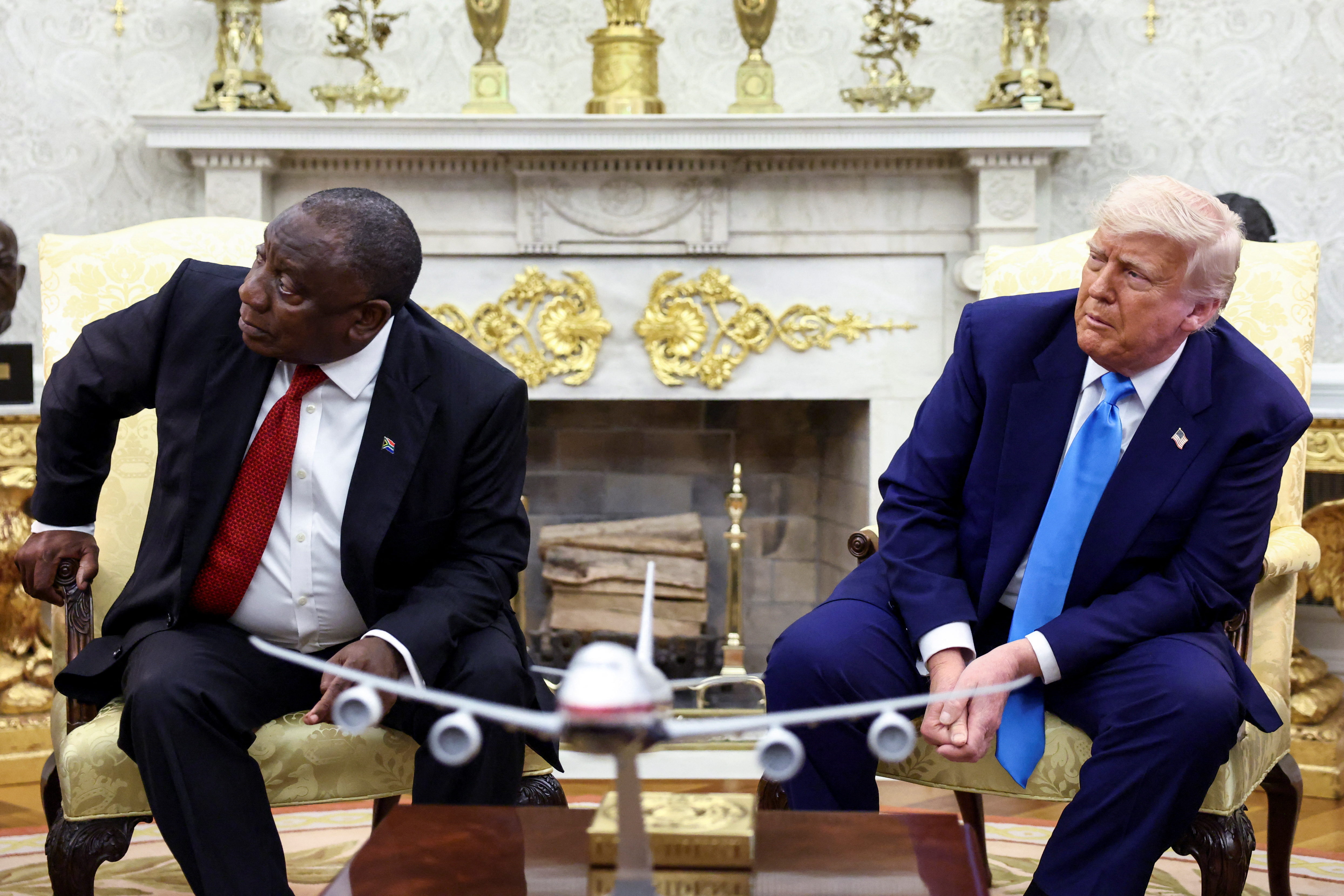 U.S. President Donald Trump and South African President Cyril Ramaphosa looks towards a monitor (not pictured) that shows videos allegedly pertaining to the genocide of white people in South Africa, in the Oval Office of the White House in Washington, D.C., U.S., May 21, 2025. REUTERS/Kevin Lamarque