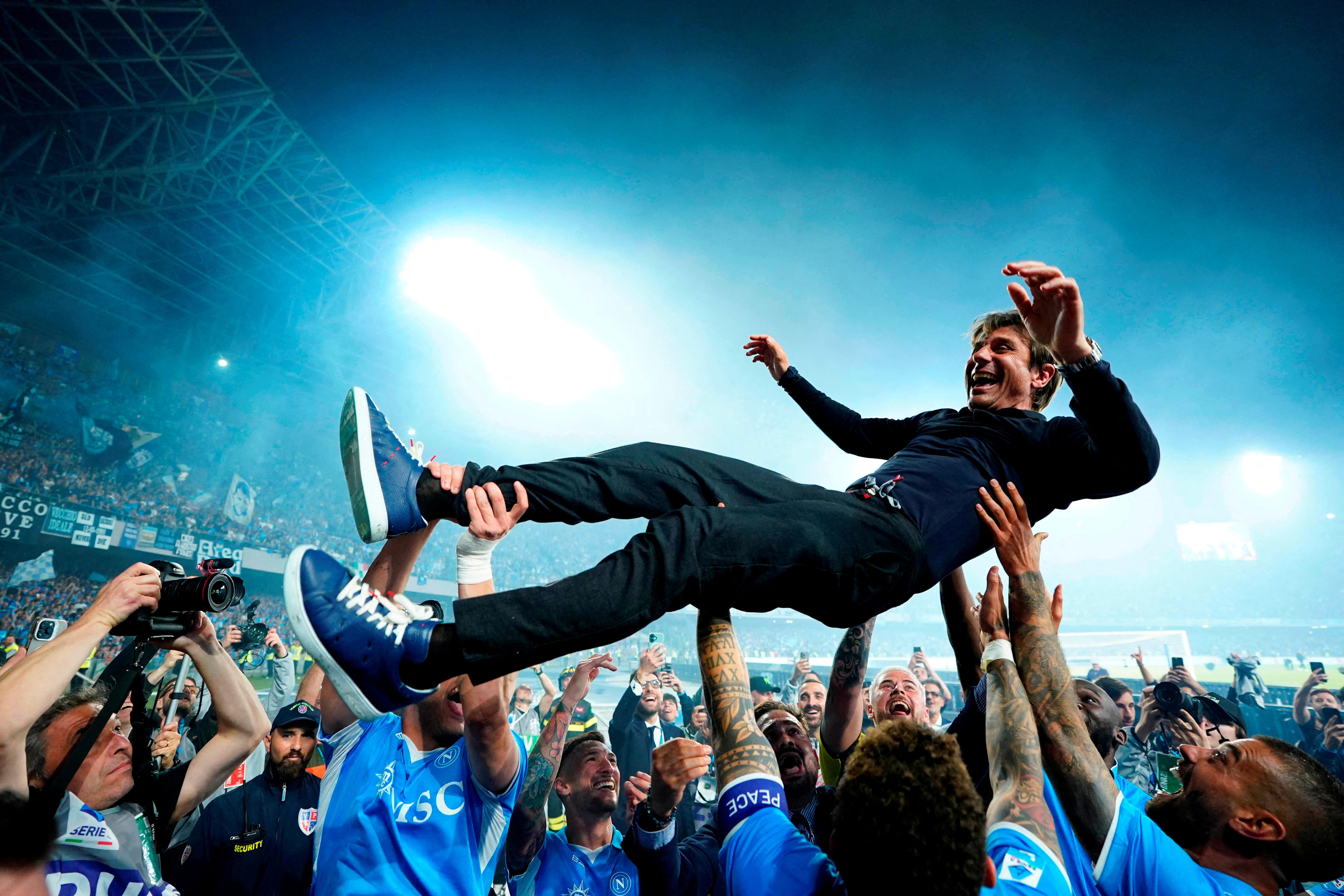 Napoli coach Antonio Conte is thrown in the air by his players