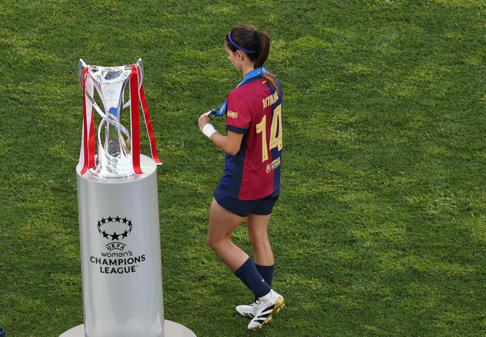Barcelona's Aitana Bonmati looks dejected after walking past the Champions League trophy